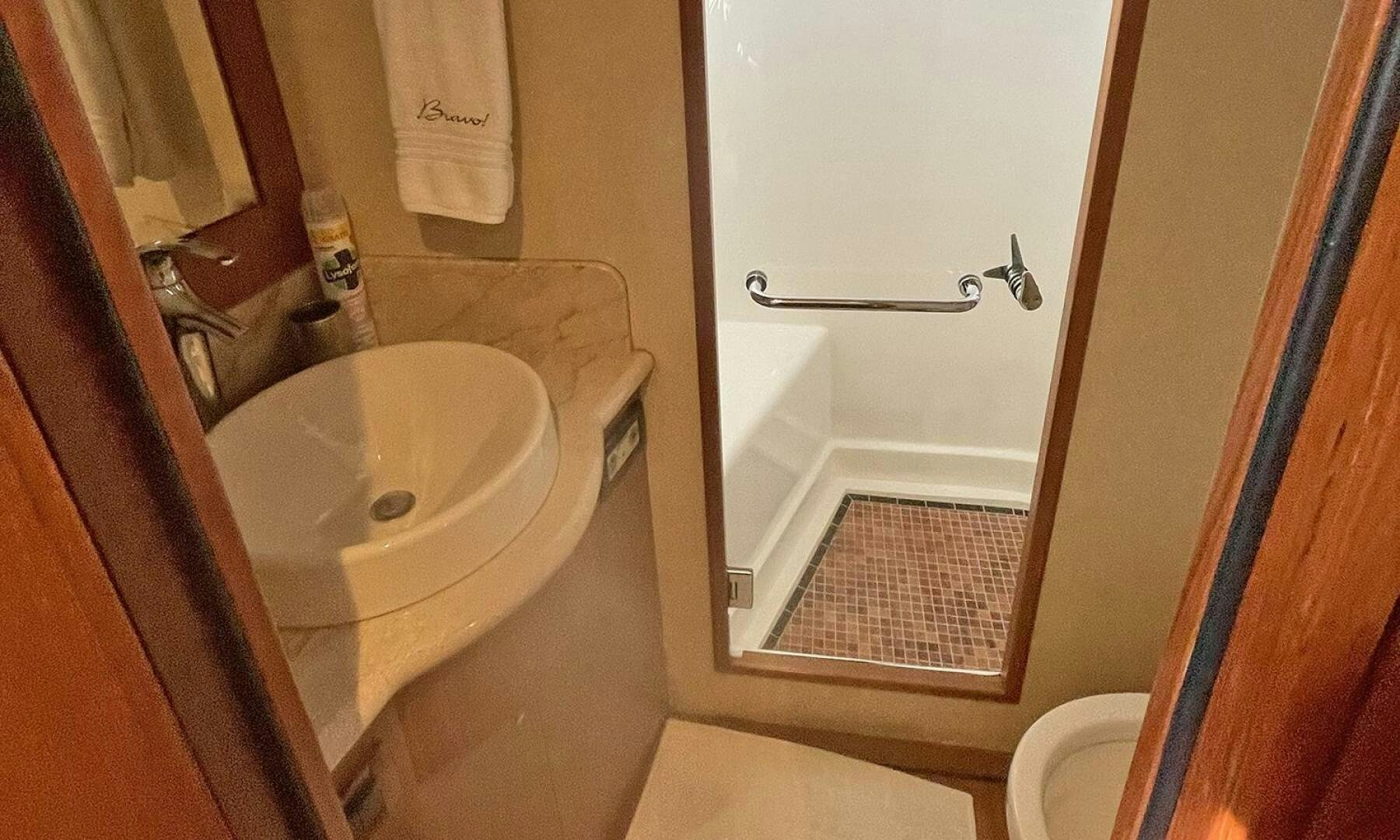 a bathroom with a sink and toilet aboard BRAVO! Yacht for Sale