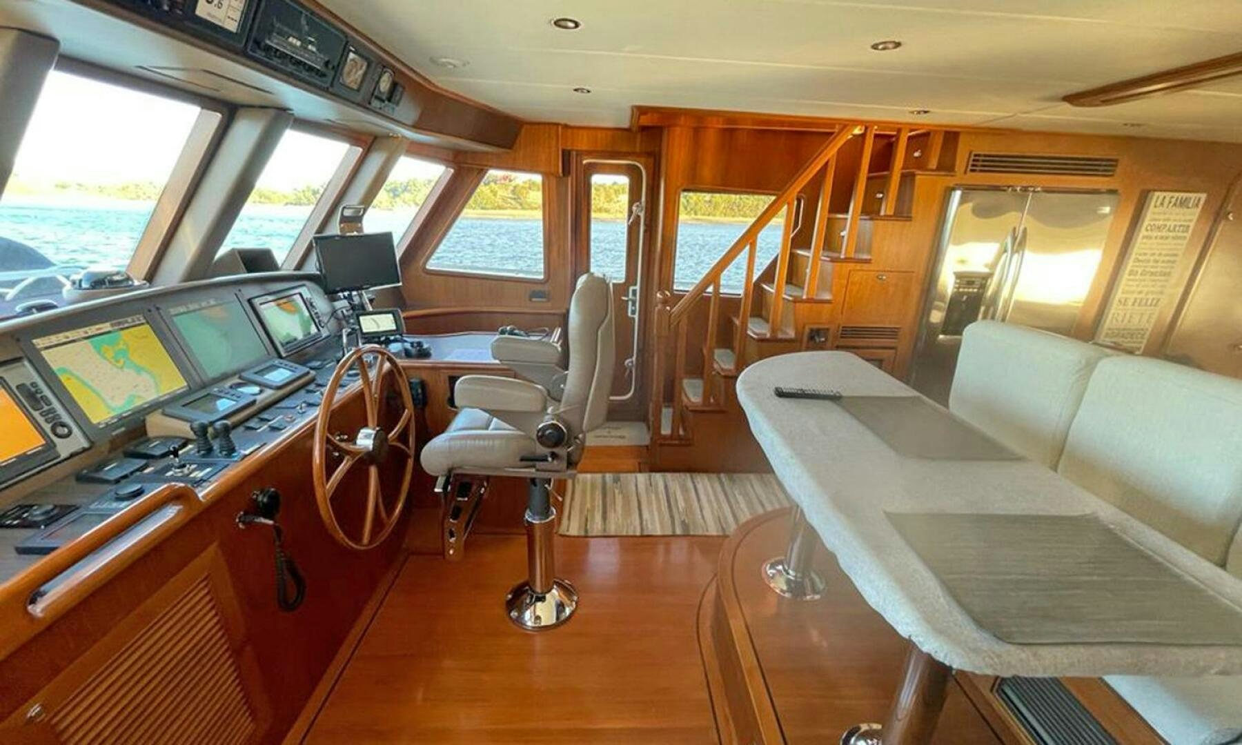 a room with a table chairs and a couch aboard BRAVO! Yacht for Sale