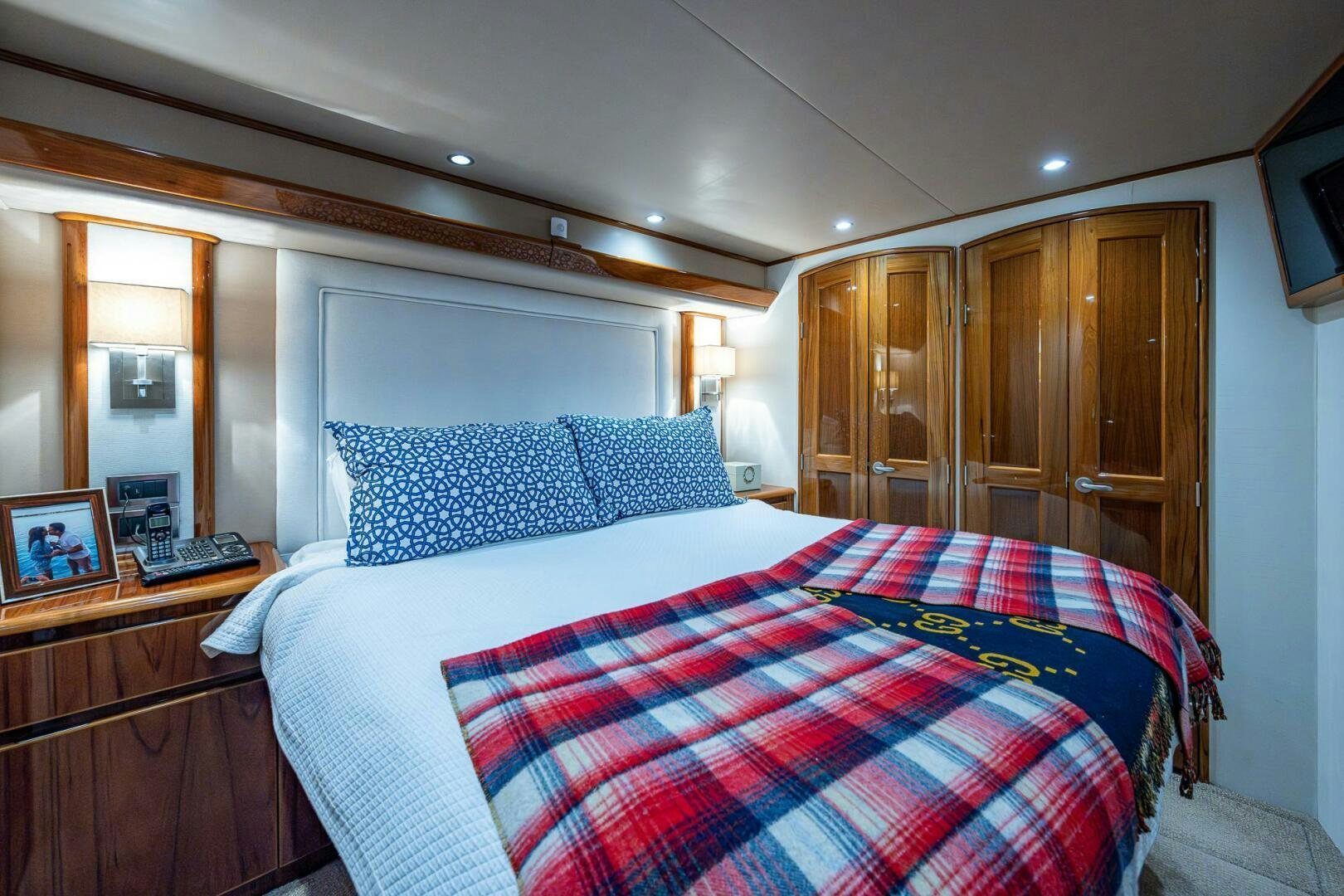 a bedroom with a bed and a dresser aboard GYPSEA Yacht for Sale