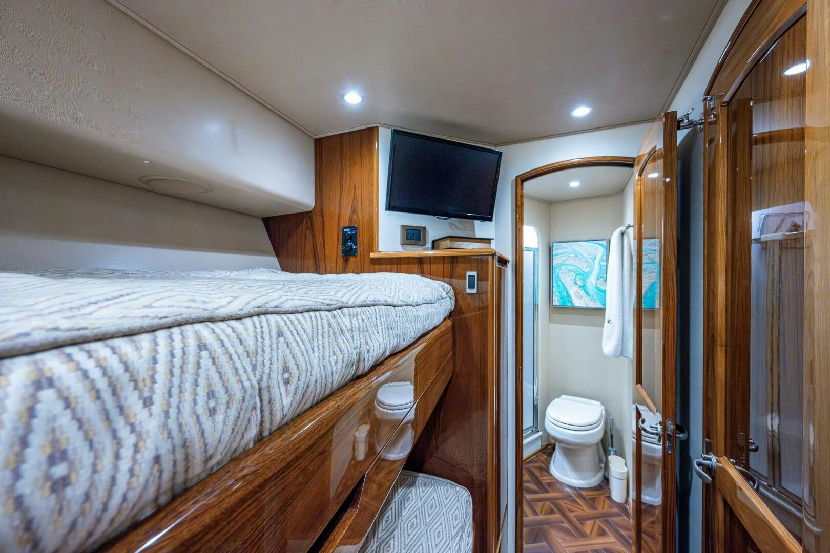 a bedroom with a bed and a television aboard GYPSEA Yacht for Sale