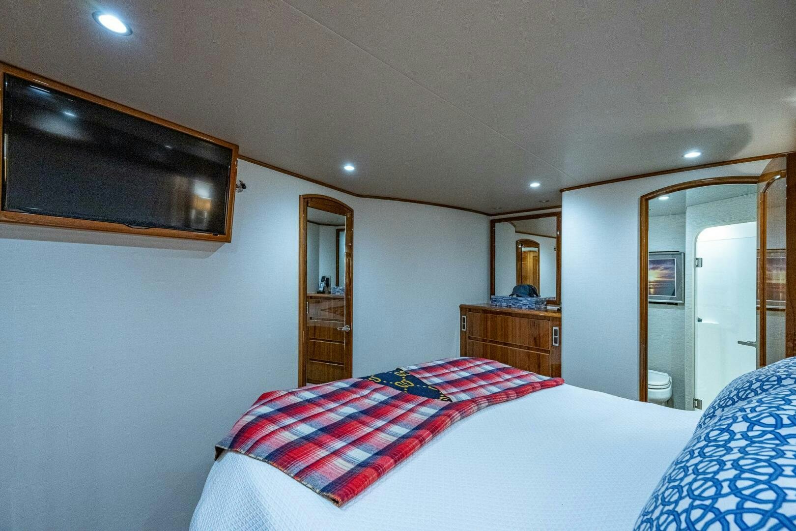 a bedroom with a bed and a mirror aboard GYPSEA Yacht for Sale