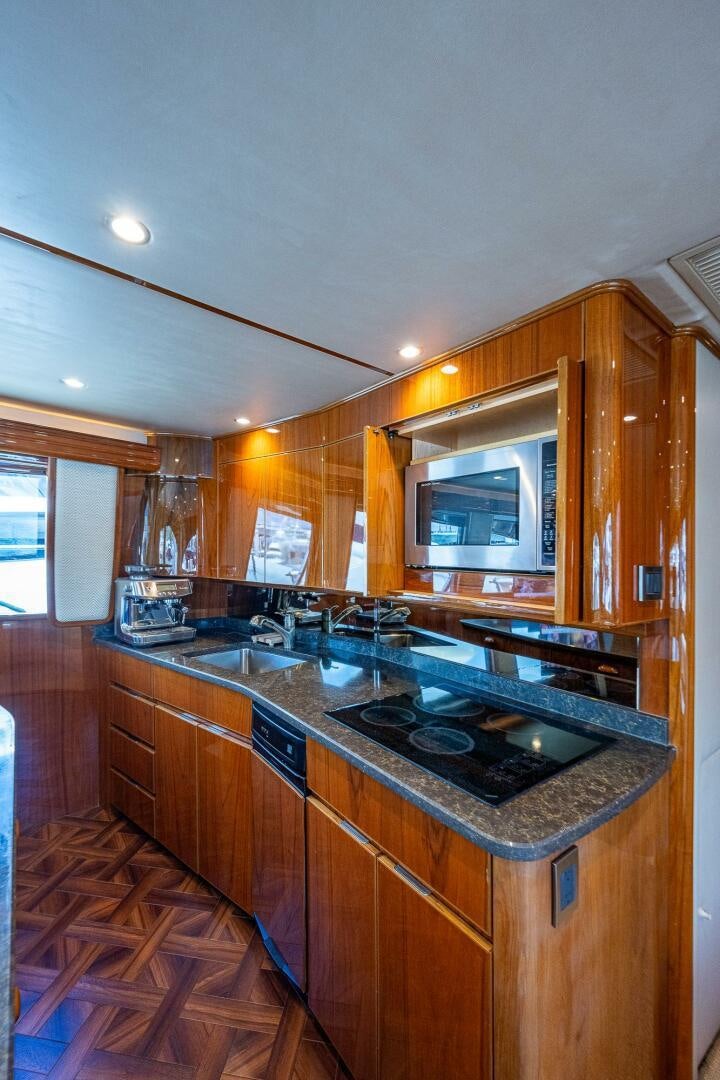 a kitchen with a stove and microwave aboard GYPSEA Yacht for Sale