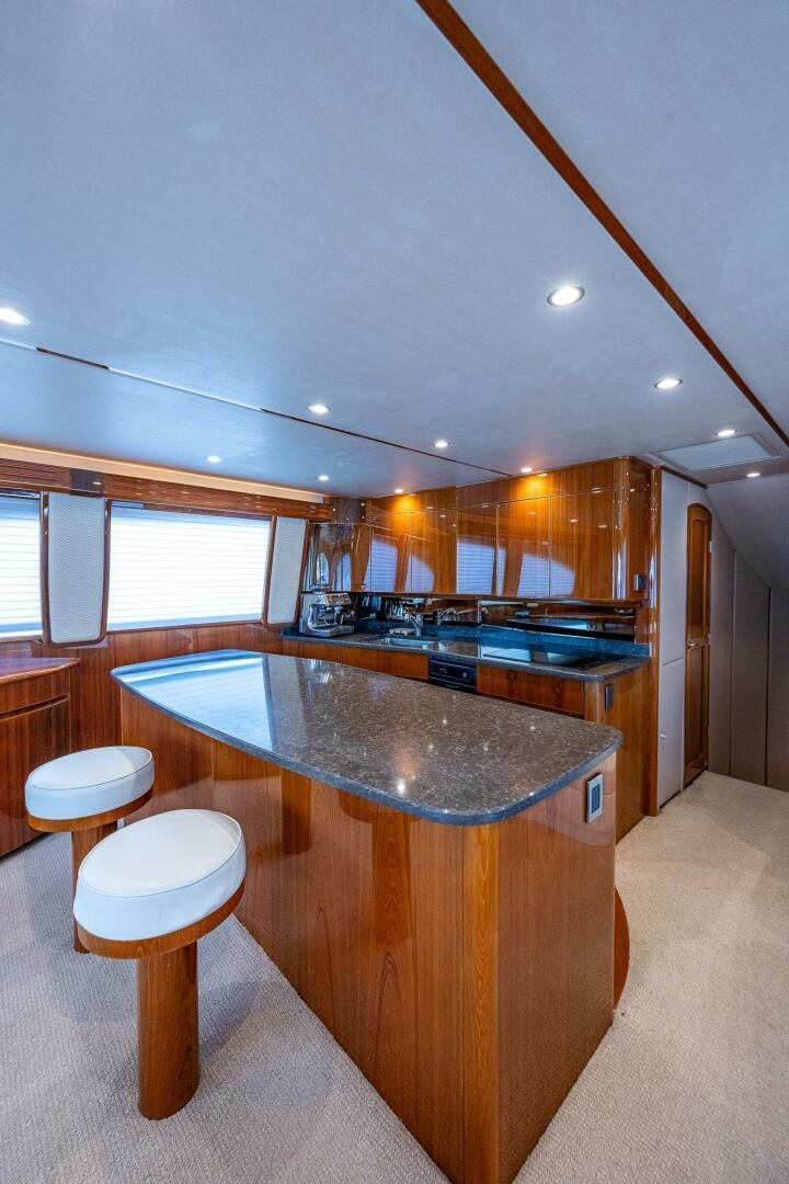 a kitchen with a bar and stools aboard GYPSEA Yacht for Sale