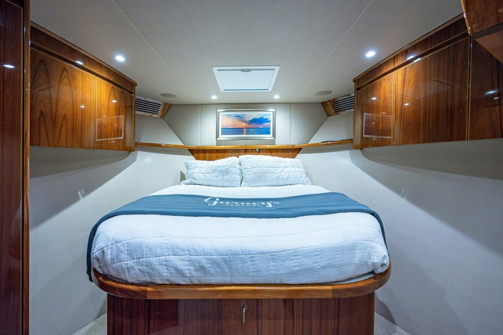 a bed with a blue sheet aboard GYPSEA Yacht for Sale
