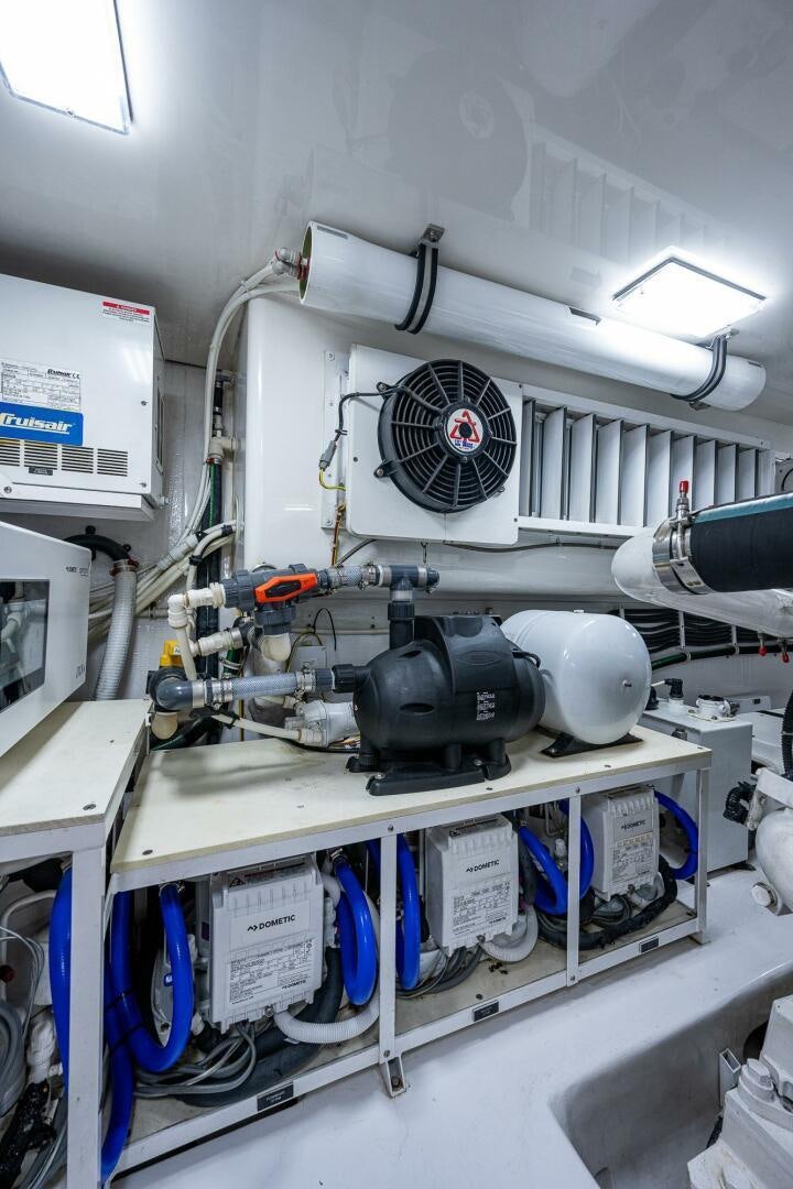 a white room with a large white machine and blue pipes aboard GYPSEA Yacht for Sale