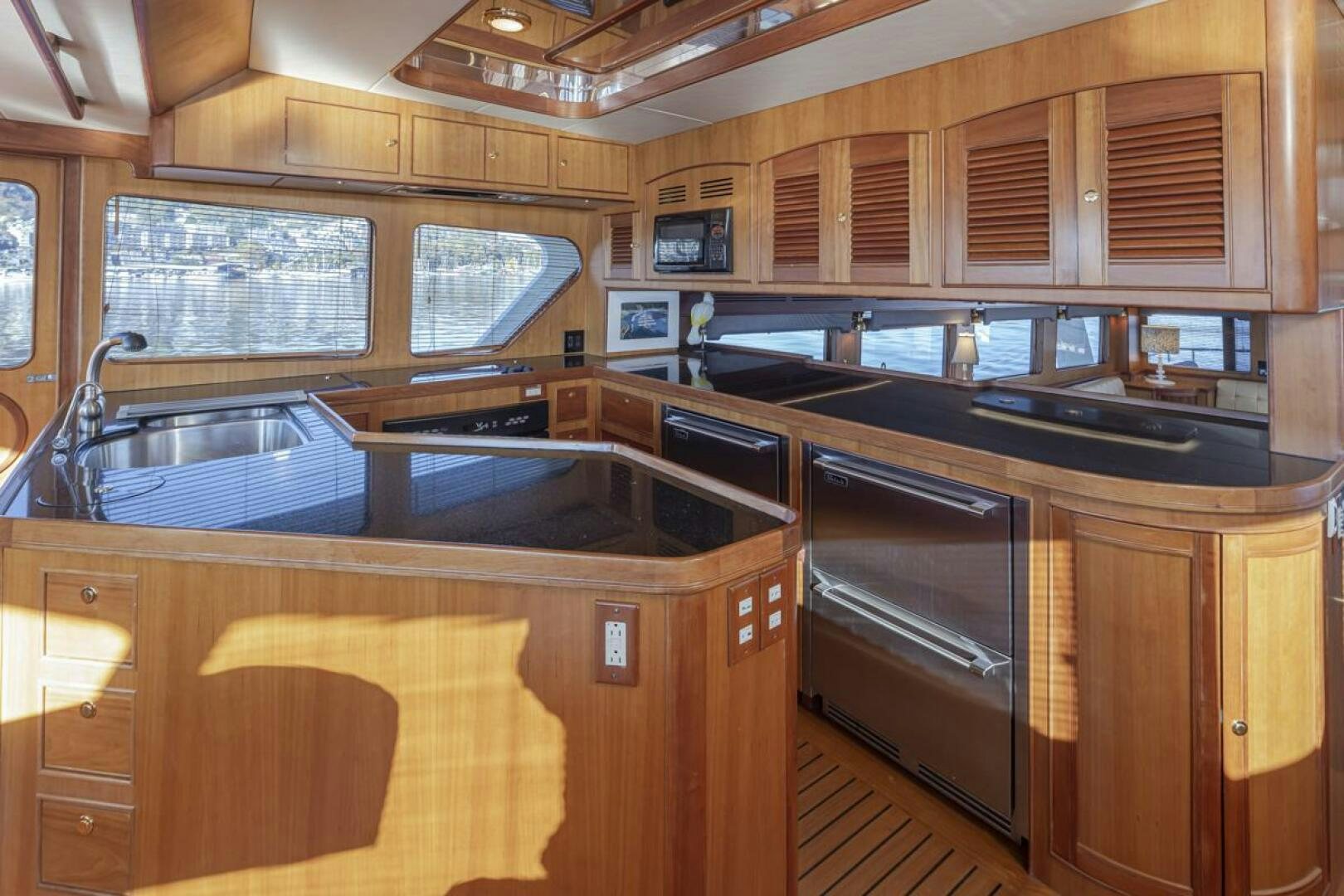 a kitchen with wooden cabinets aboard HYJAC Yacht for Sale