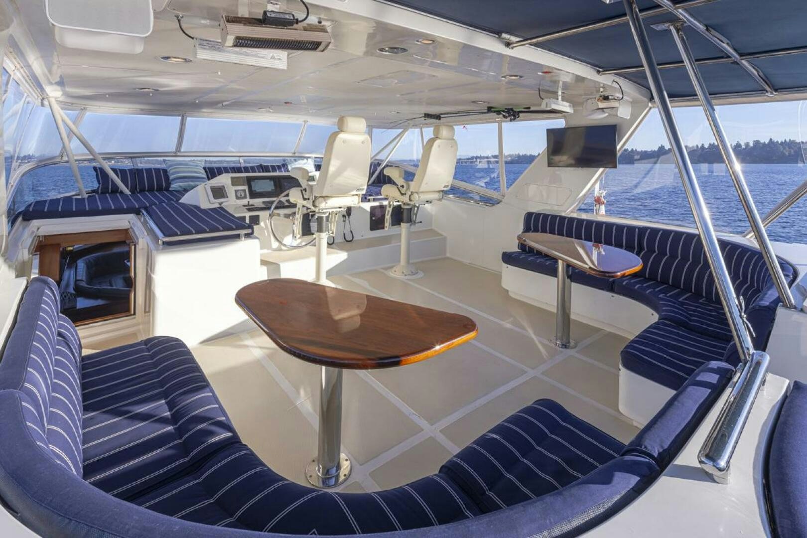 a boat with a table and chairs aboard HYJAC Yacht for Sale