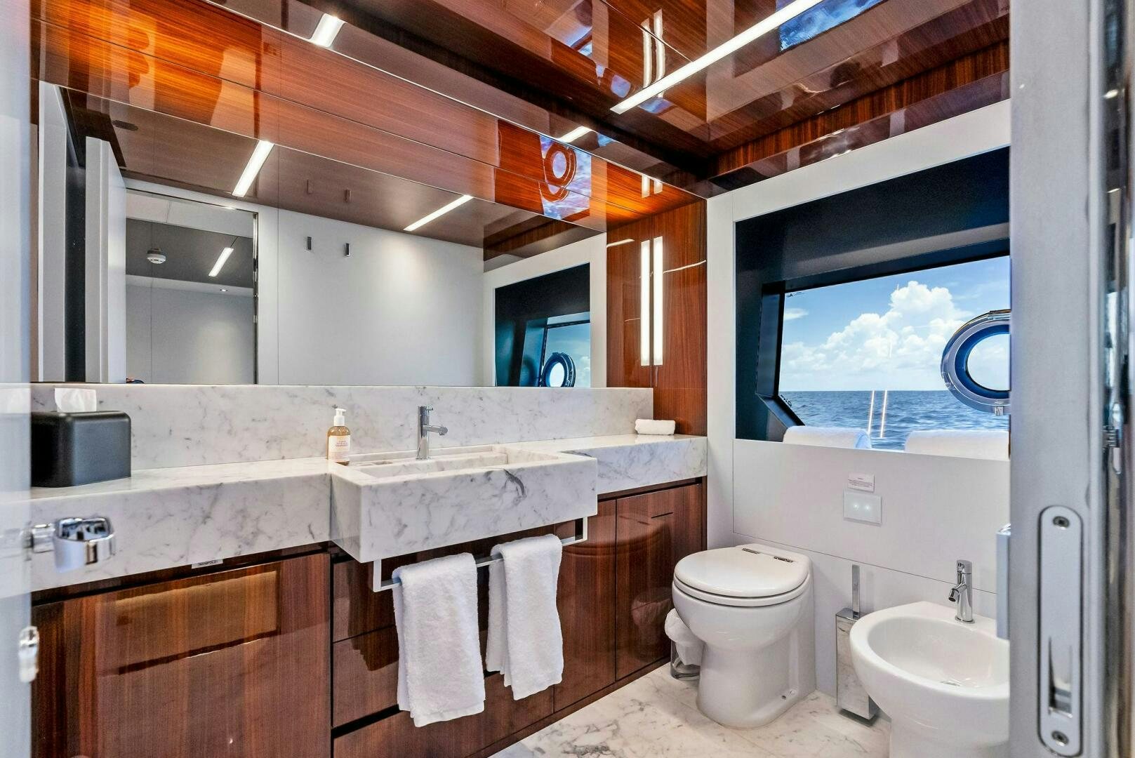 a bathroom with a large window aboard NO SURRENDER Yacht for Sale