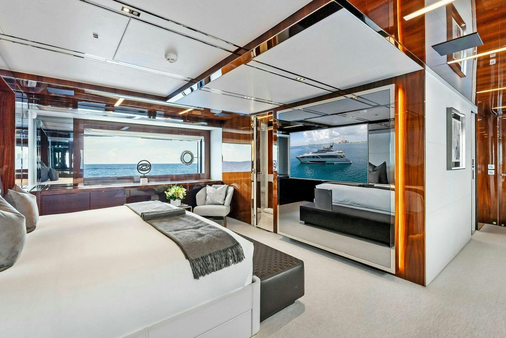 a room with a large mirror and a bed aboard NO SURRENDER Yacht for Sale
