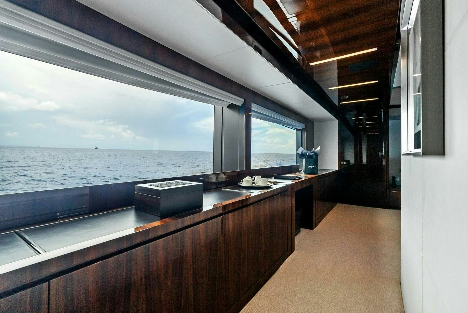 a large kitchen with a large window overlooking the ocean aboard NO SURRENDER Yacht for Sale