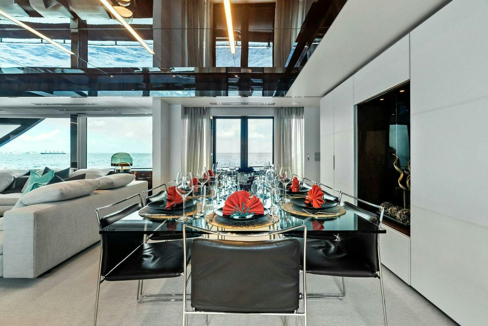 a living room with a table and chairs aboard NO SURRENDER Yacht for Sale