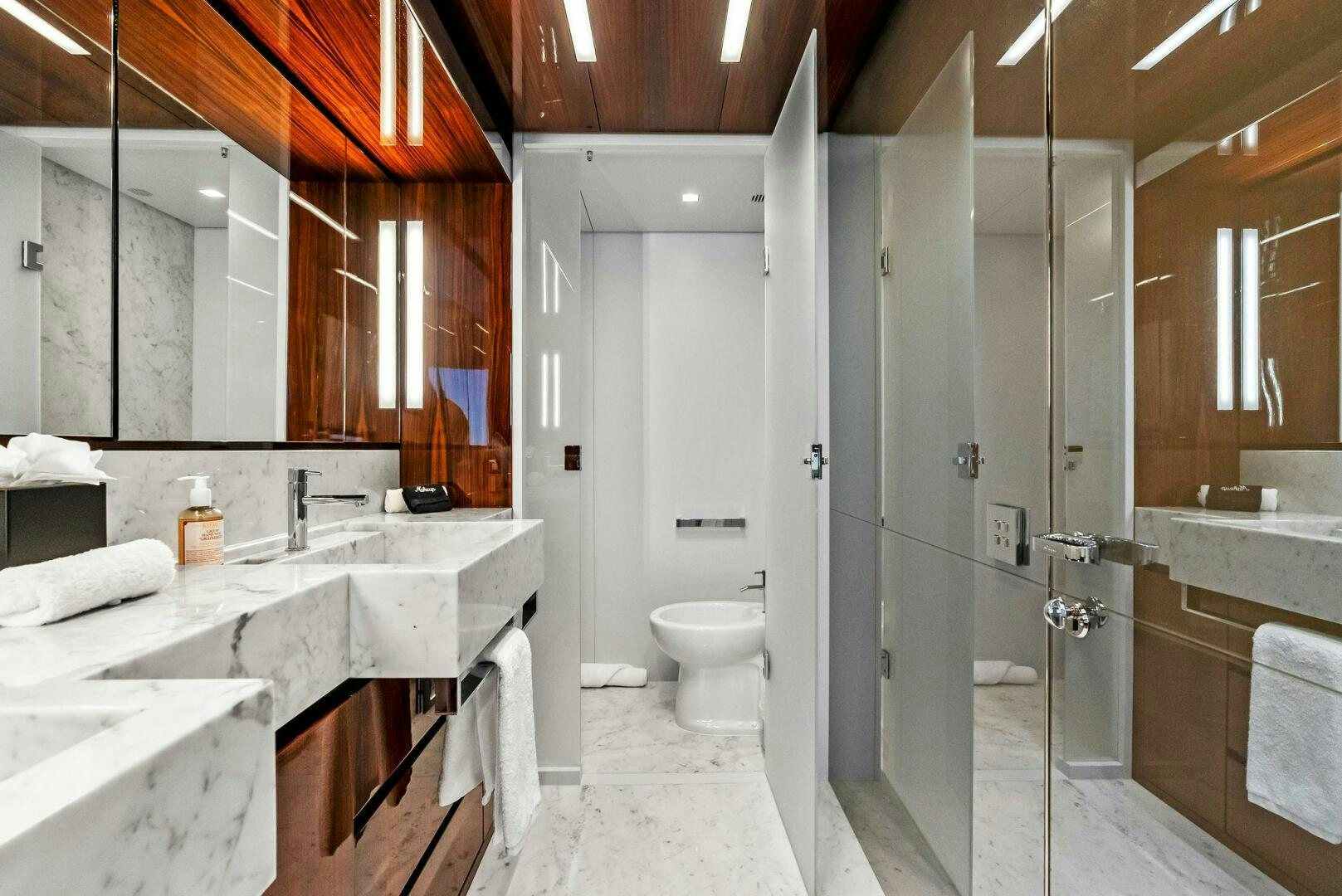 a bathroom with a sink toilet and bathtub aboard NO SURRENDER Yacht for Sale