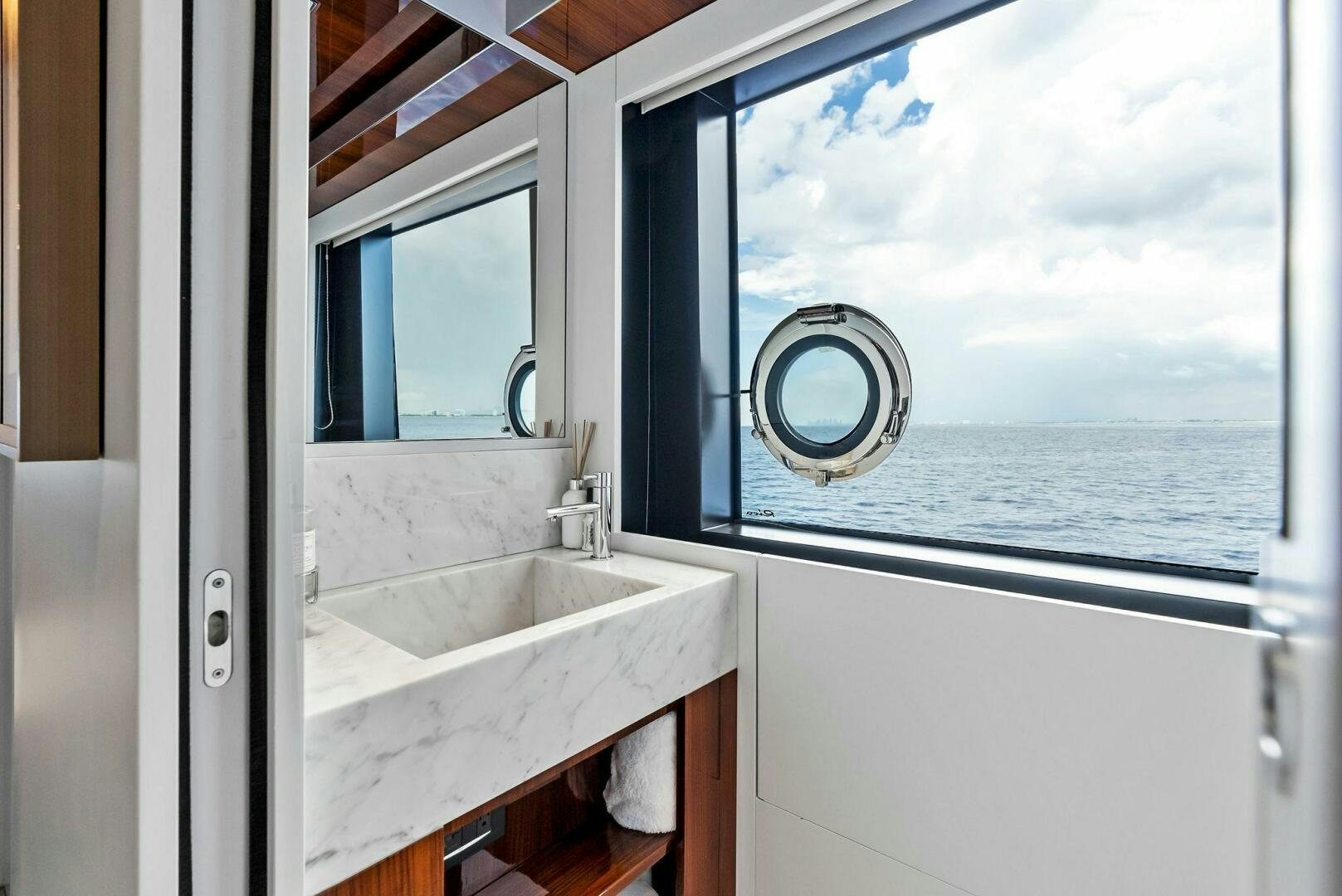 a bathroom with a sink and a window aboard NO SURRENDER Yacht for Sale