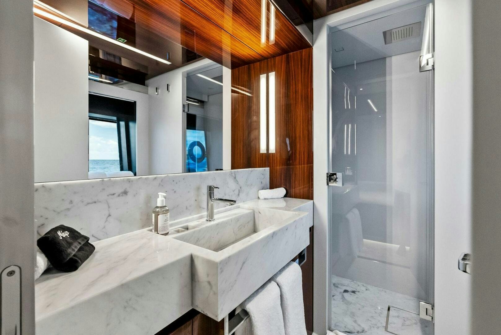 a bathroom with a sink and a mirror aboard NO SURRENDER Yacht for Sale