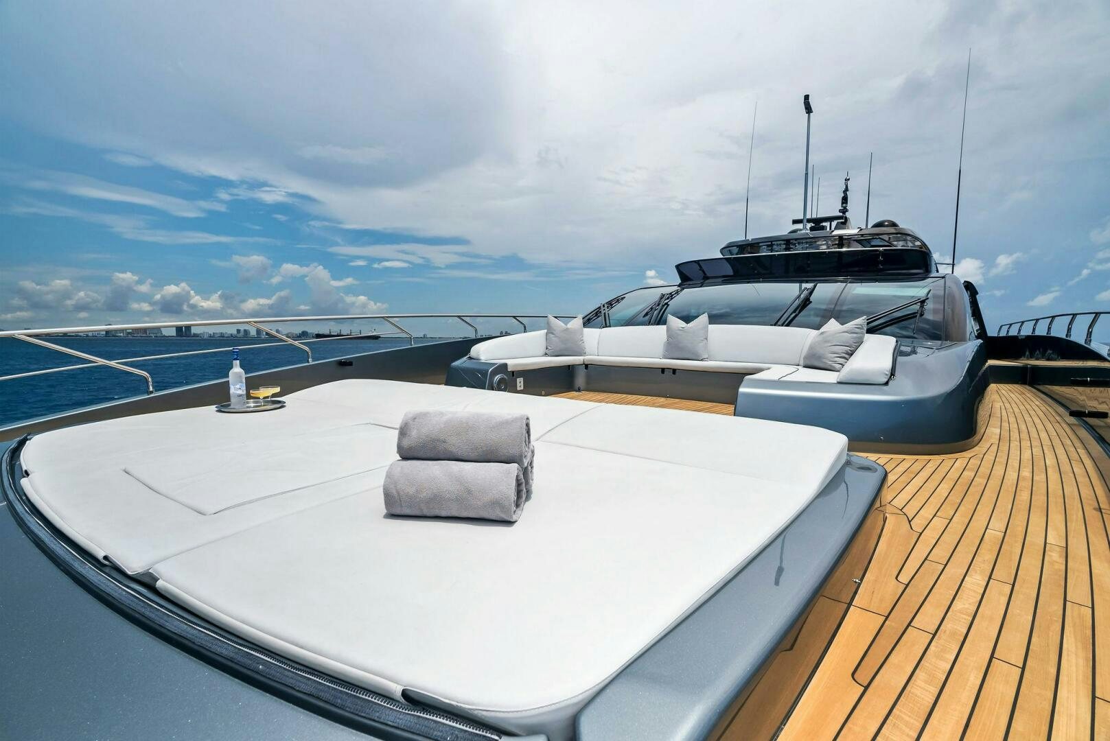 a deck with a couple of boats on it and a view of the water and land below aboard NO SURRENDER Yacht for Sale