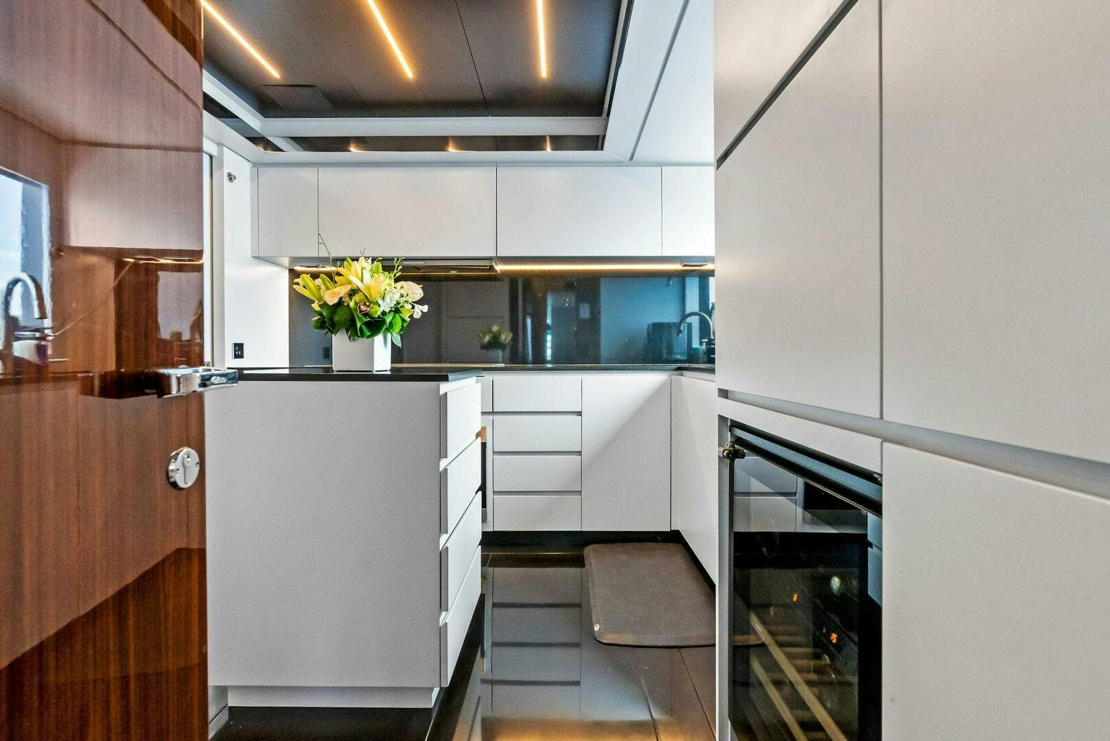 a kitchen with white cabinets aboard NO SURRENDER Yacht for Sale