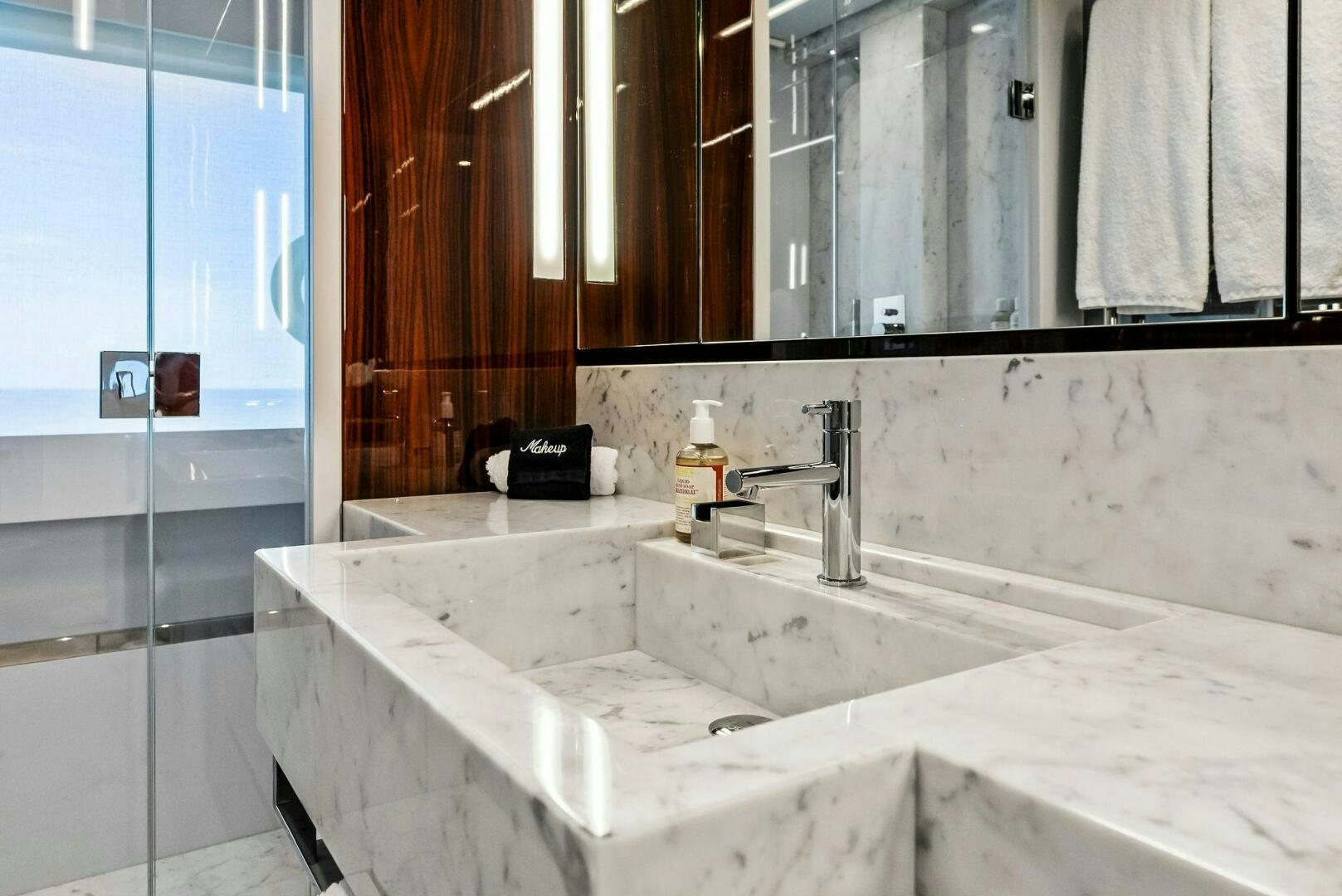 a bathroom with a countertop sink and a mirror aboard NO SURRENDER Yacht for Sale