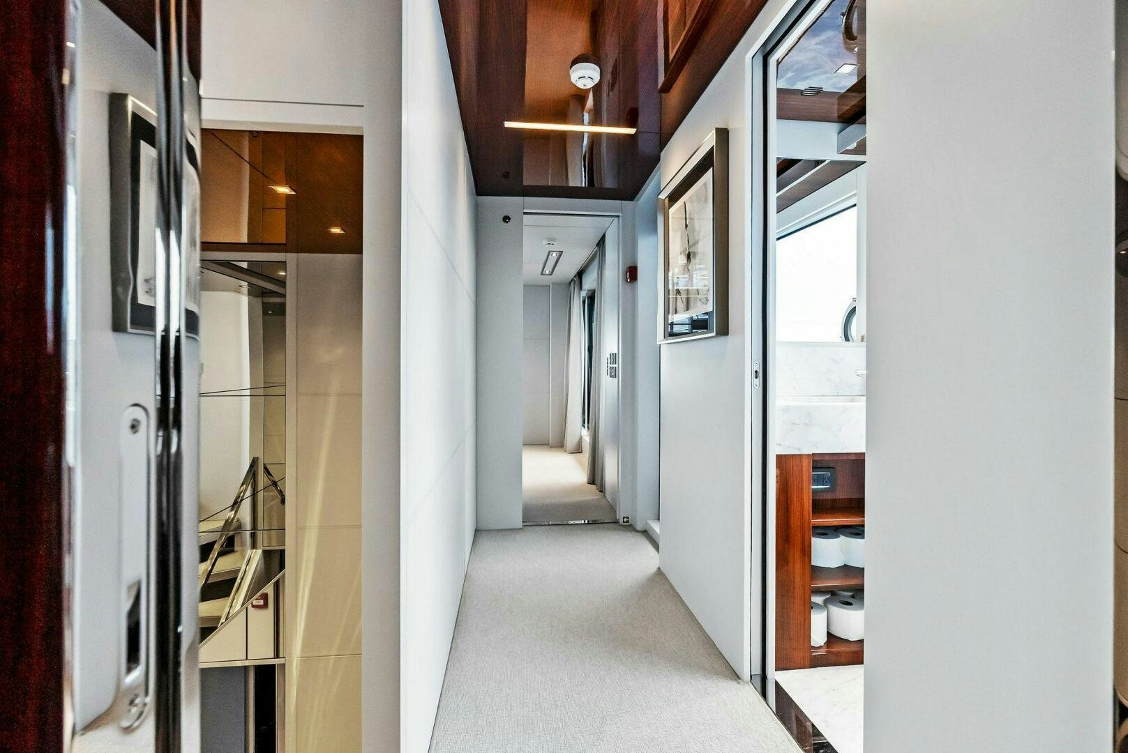 a hallway with white walls aboard NO SURRENDER Yacht for Sale