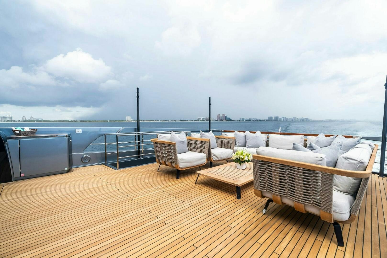 a deck with chairs and a table on it aboard NO SURRENDER Yacht for Sale