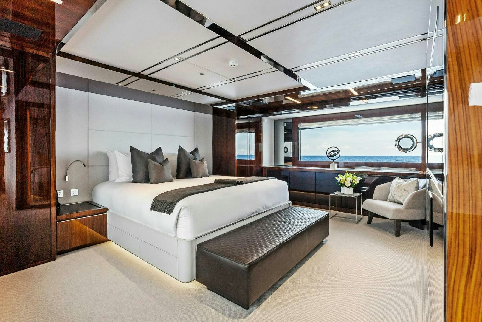 a room with a bed and a chair aboard NO SURRENDER Yacht for Sale