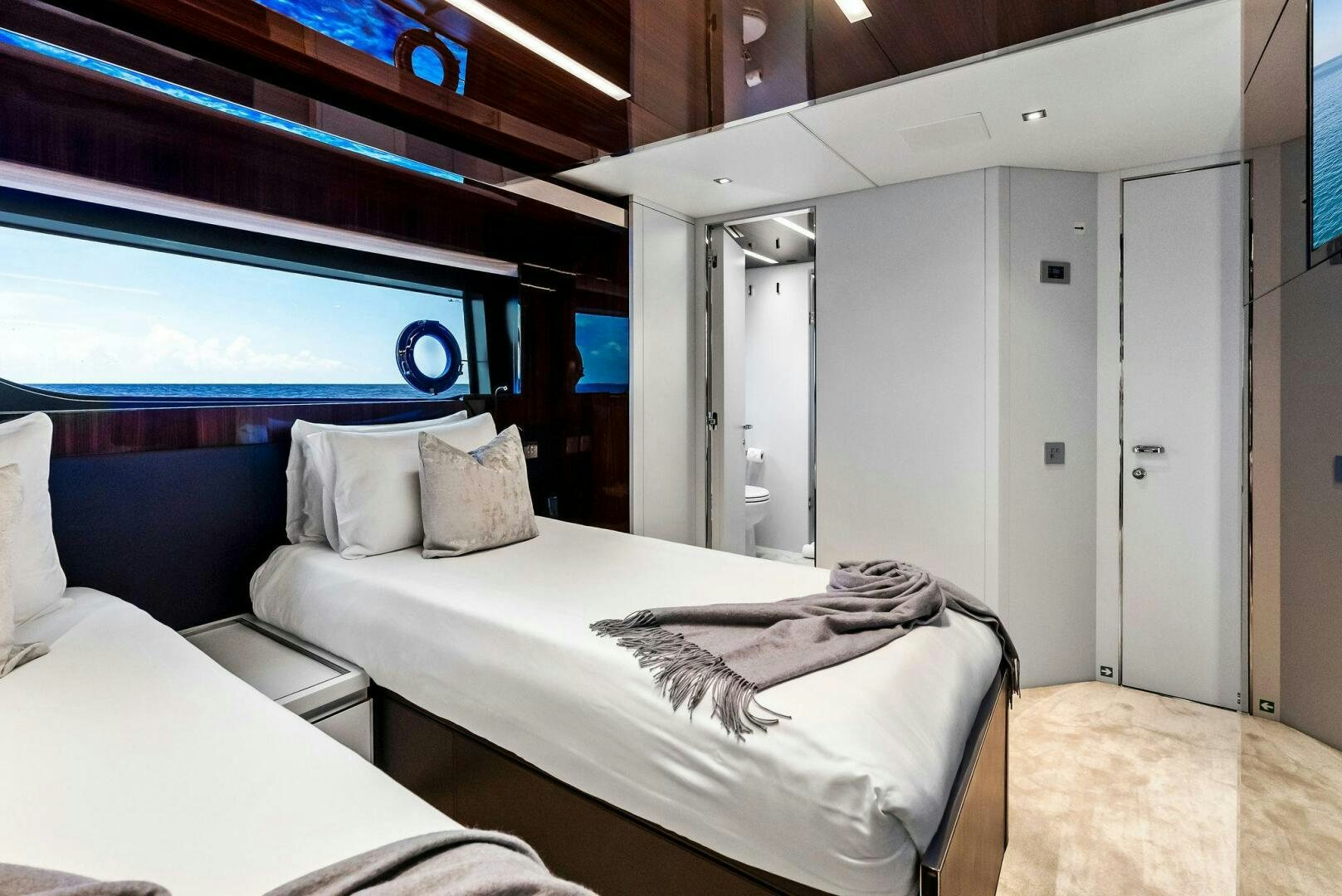 a room with beds and a window aboard NO SURRENDER Yacht for Sale