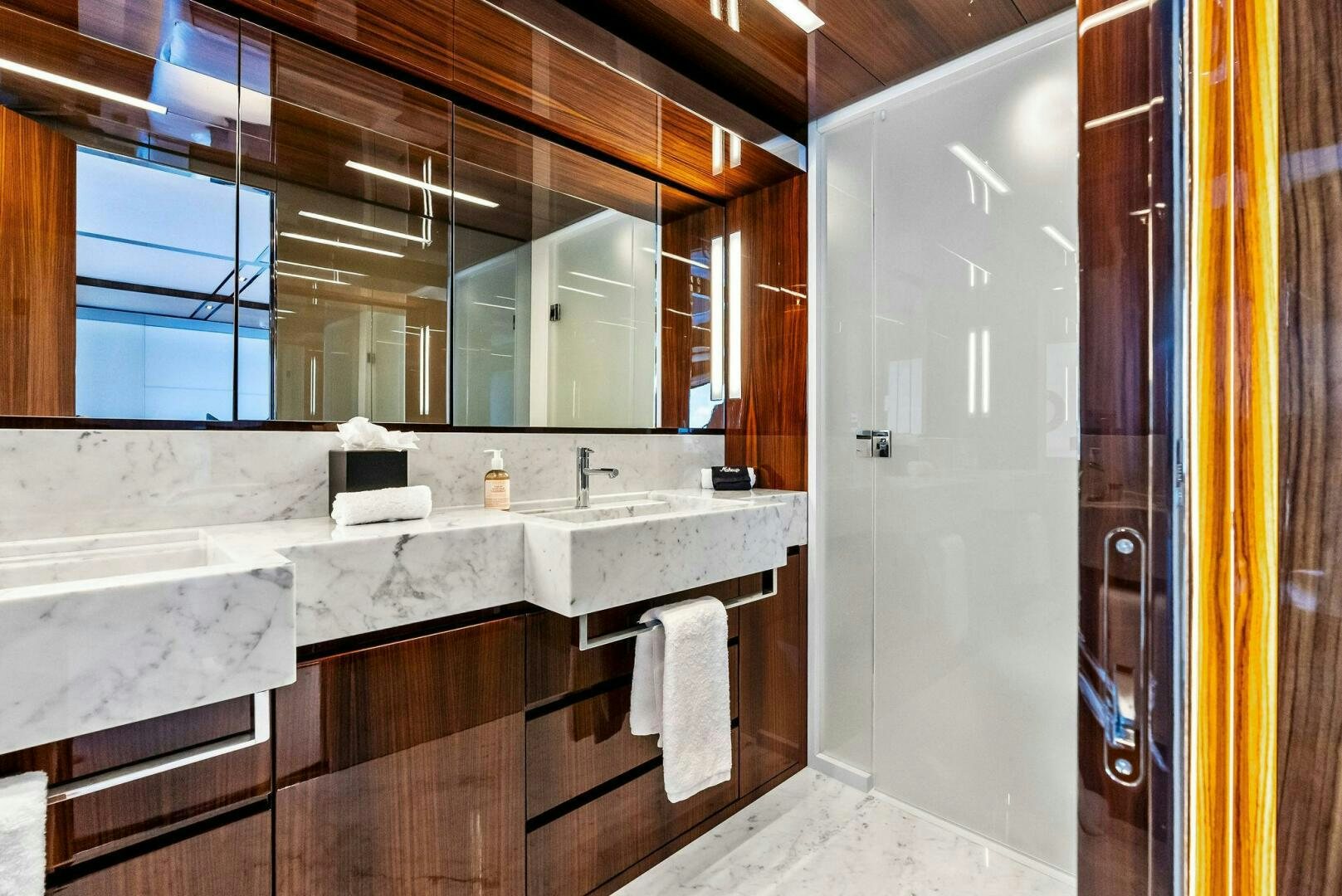 a bathroom with a large mirror aboard NO SURRENDER Yacht for Sale