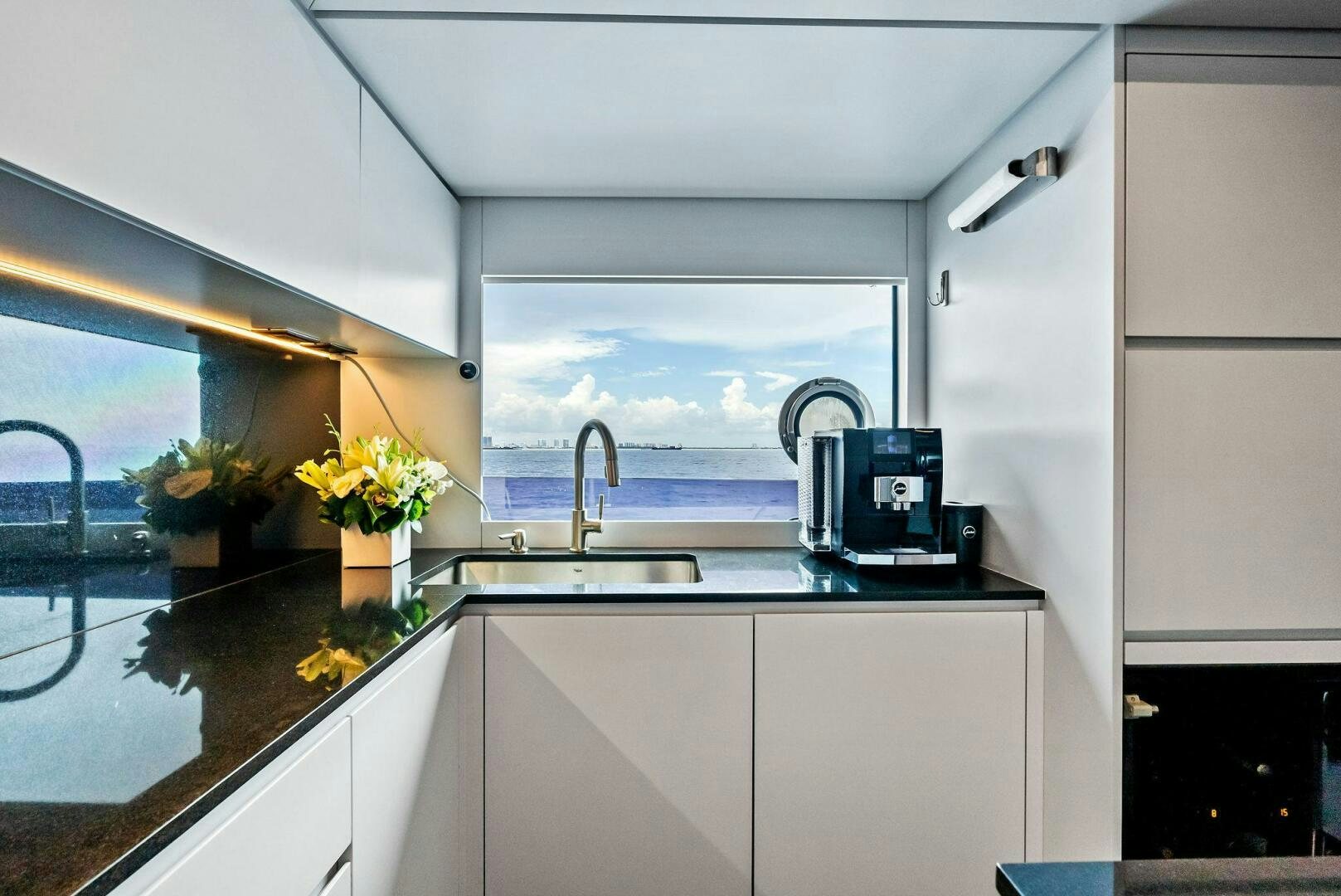 a kitchen with white cabinets aboard NO SURRENDER Yacht for Sale