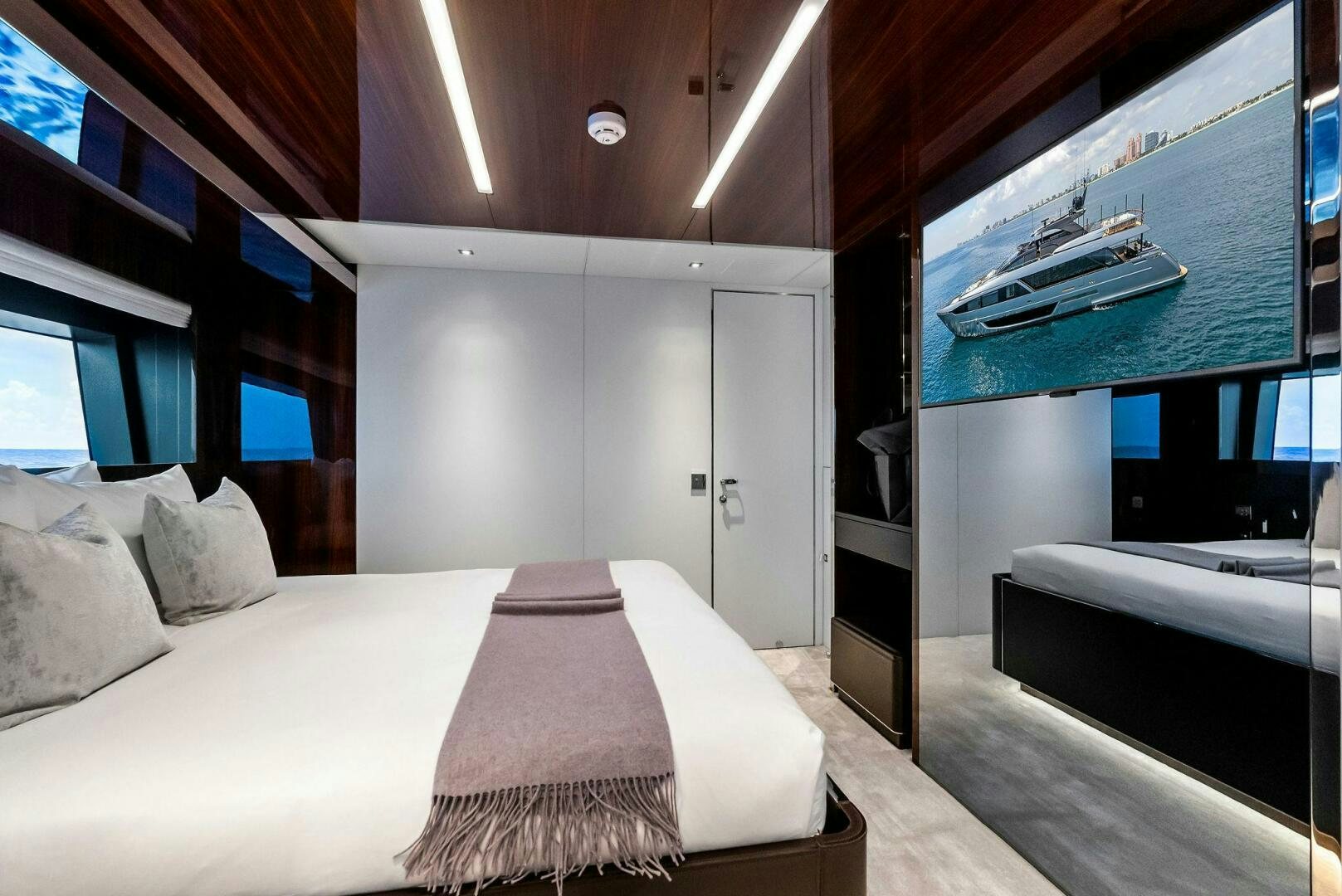 a room with a bed and a window aboard NO SURRENDER Yacht for Sale