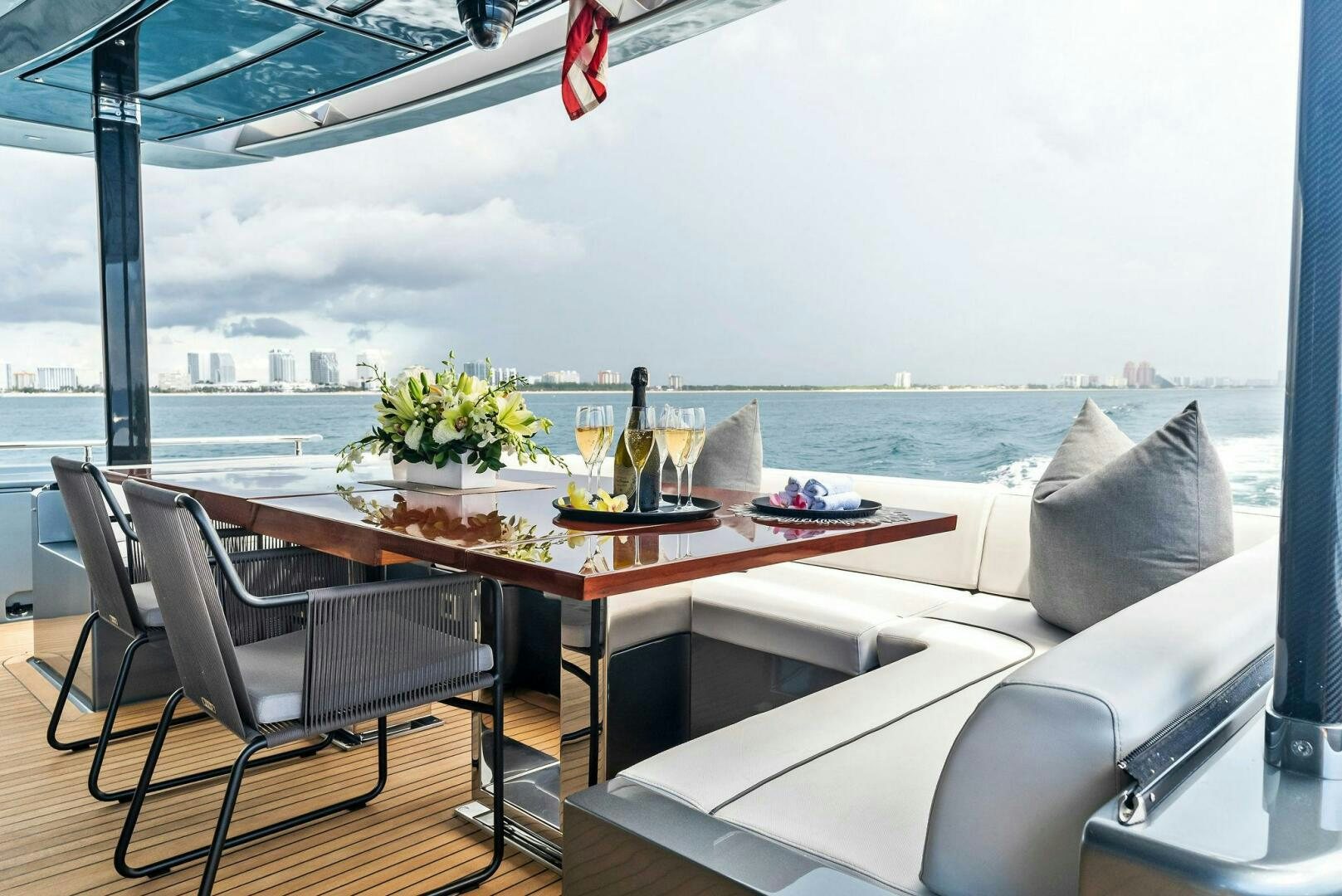 a table with chairs and a view of the water aboard NO SURRENDER Yacht for Sale