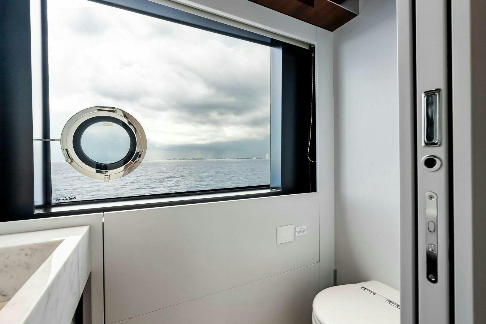 a bathroom with a large window aboard NO SURRENDER Yacht for Sale