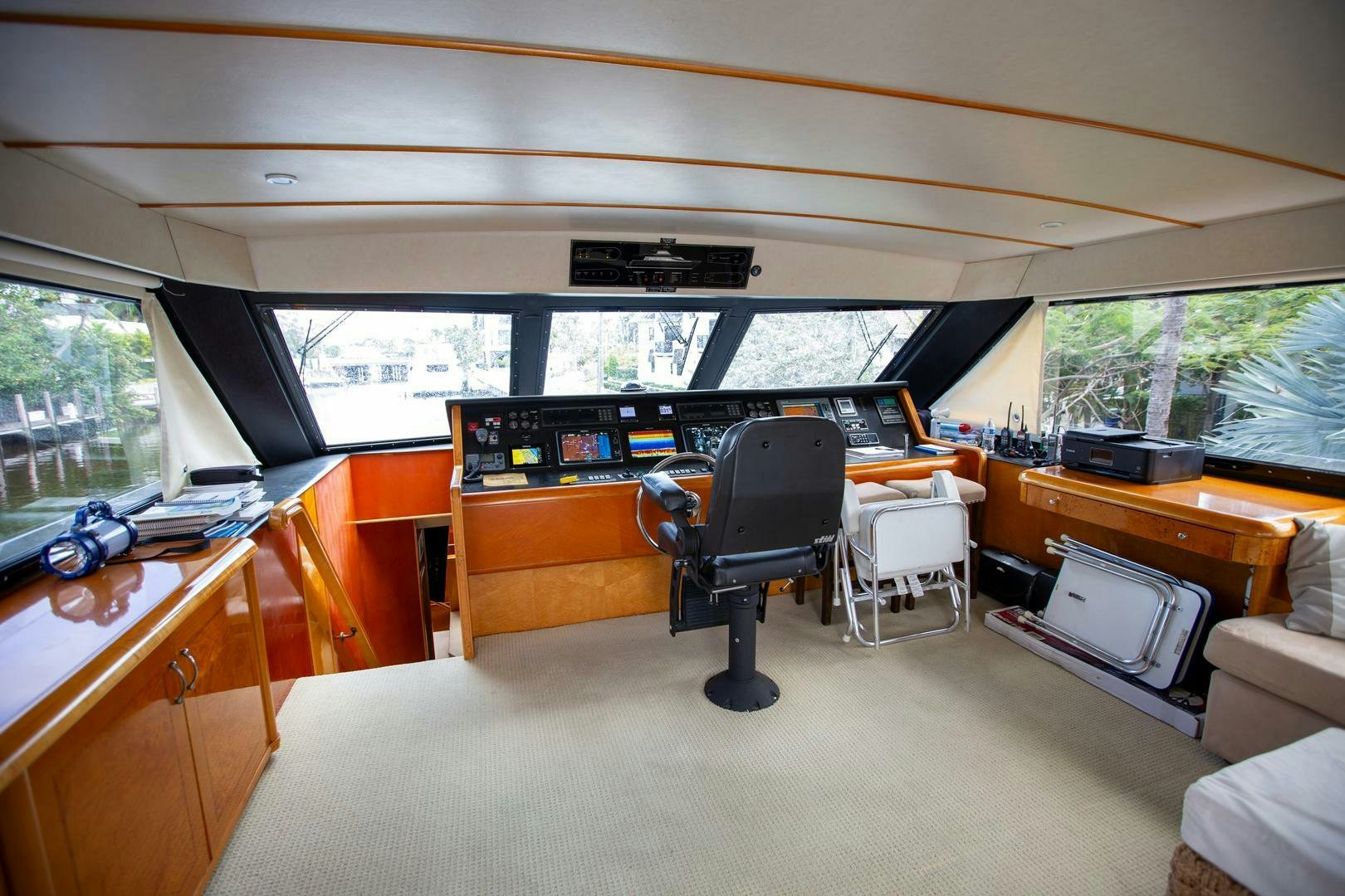 a room with a piano and a chair aboard PAINKILLER Yacht for Sale