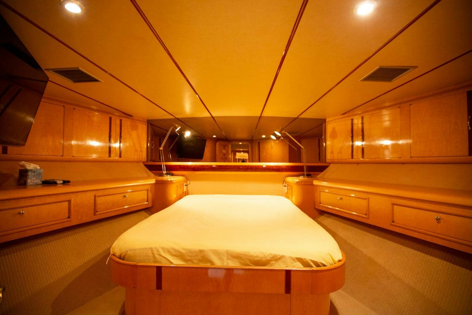 a room with a bed and cabinets aboard PAINKILLER Yacht for Sale