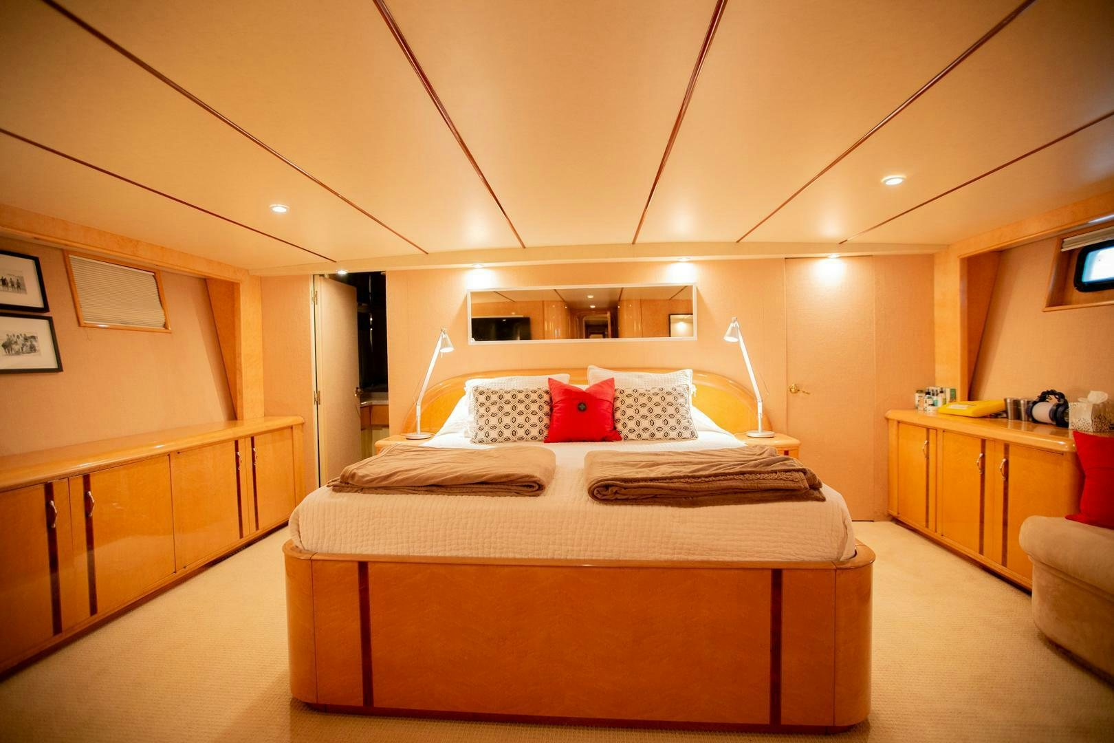 a bedroom with a bed and a desk aboard PAINKILLER Yacht for Sale