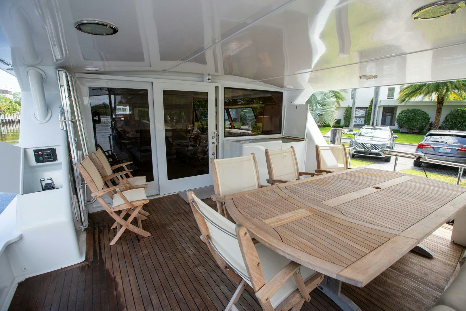 a room with a table chairs and a car aboard PAINKILLER Yacht for Sale