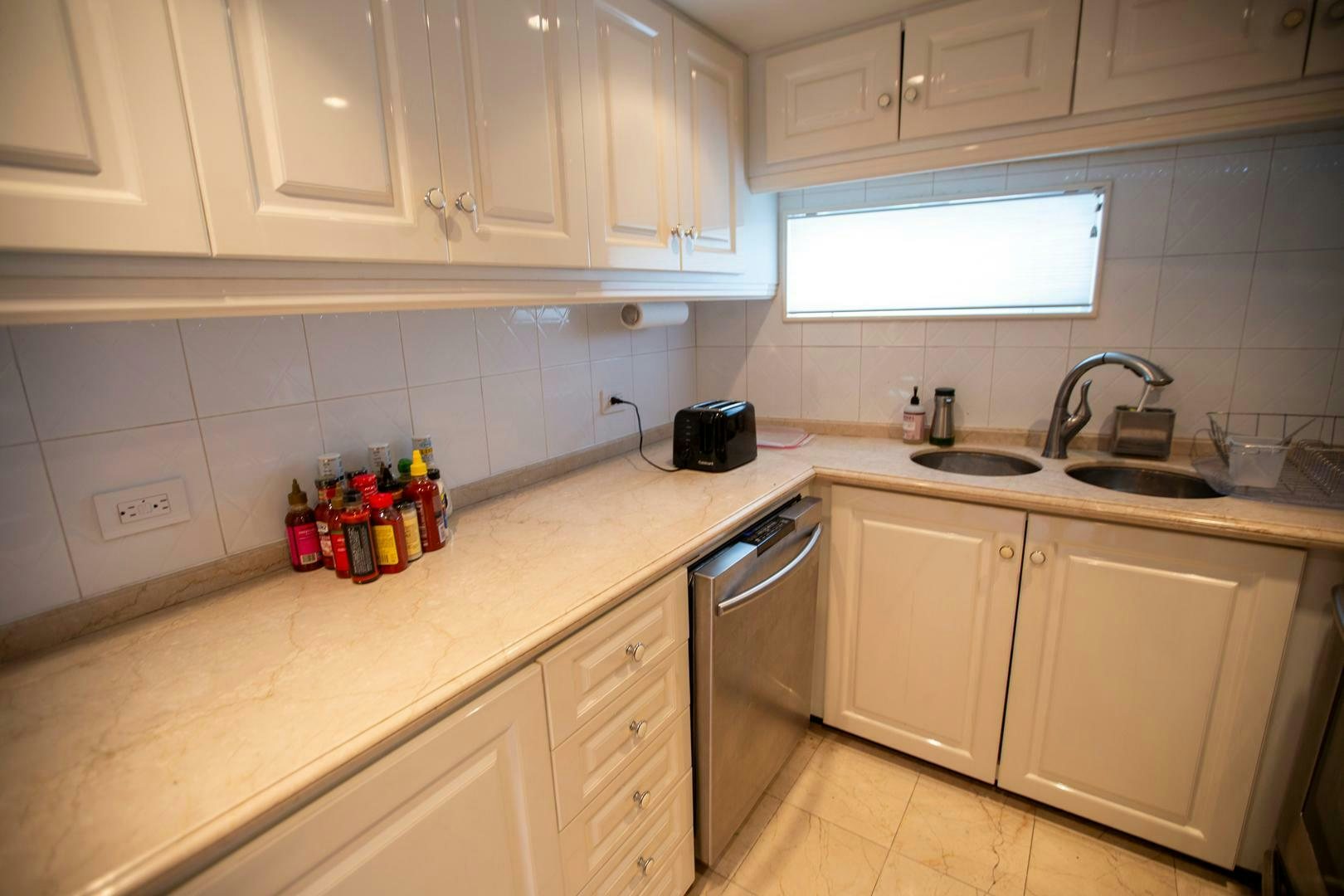 a kitchen with white cabinets aboard PAINKILLER Yacht for Sale