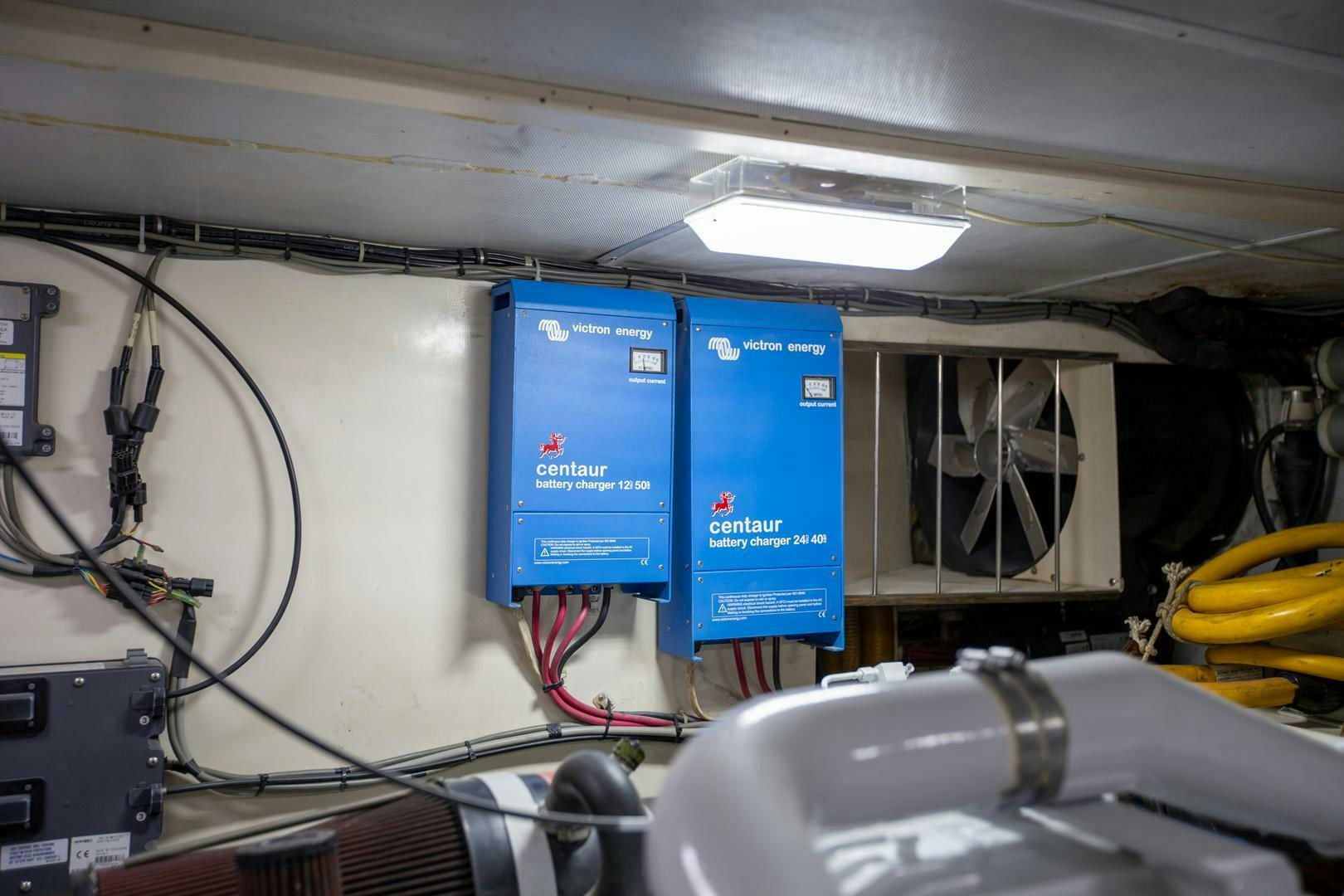 a room with a blue sign and a white board aboard PAINKILLER Yacht for Sale