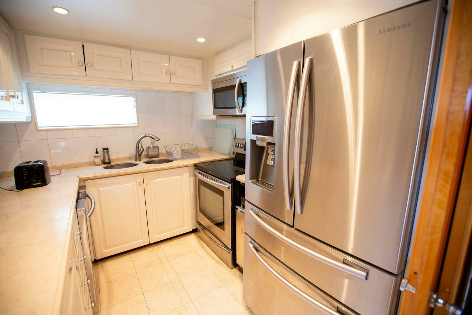 a kitchen with stainless steel appliances aboard PAINKILLER Yacht for Sale