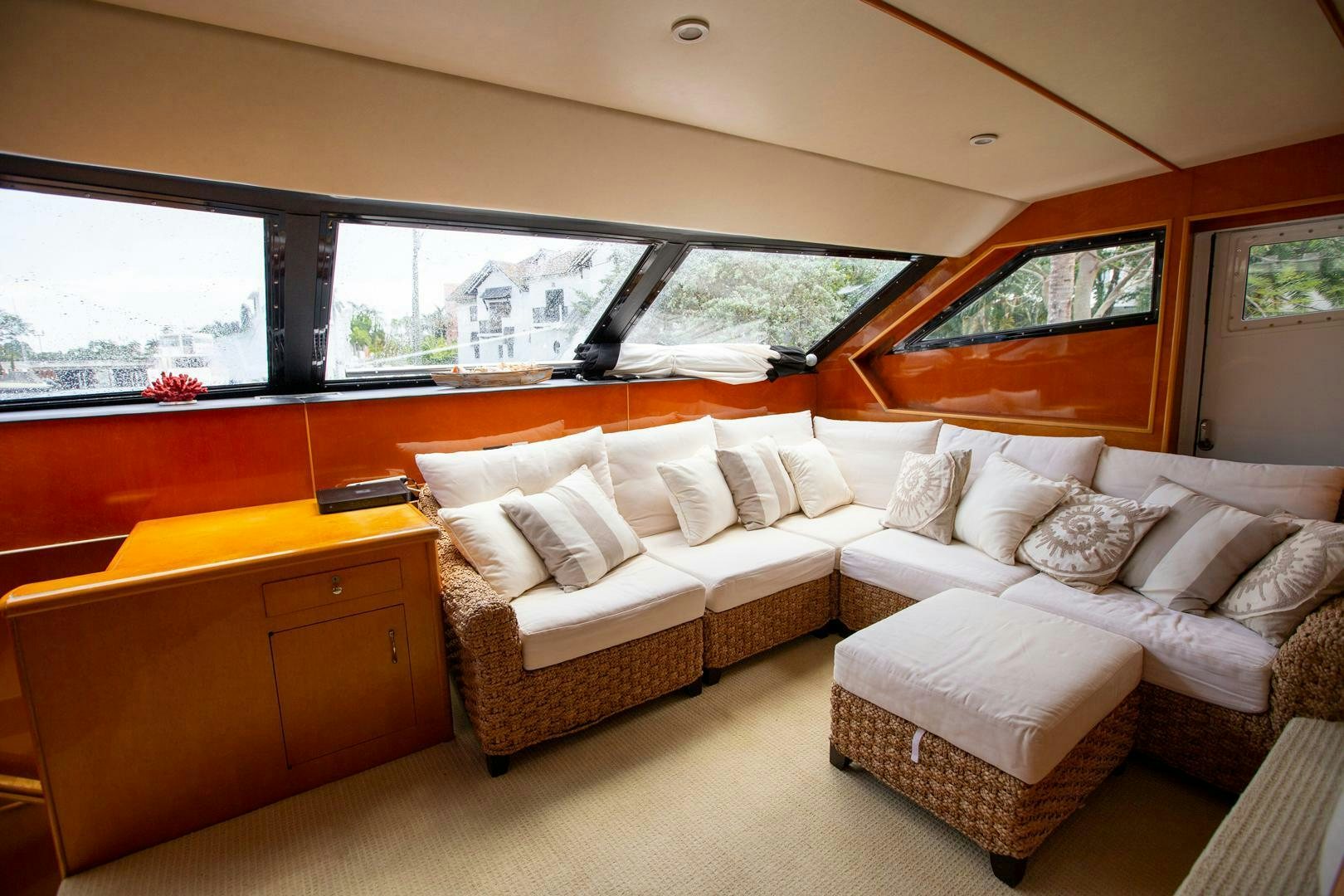 a living room with a couch and a window aboard PAINKILLER Yacht for Sale