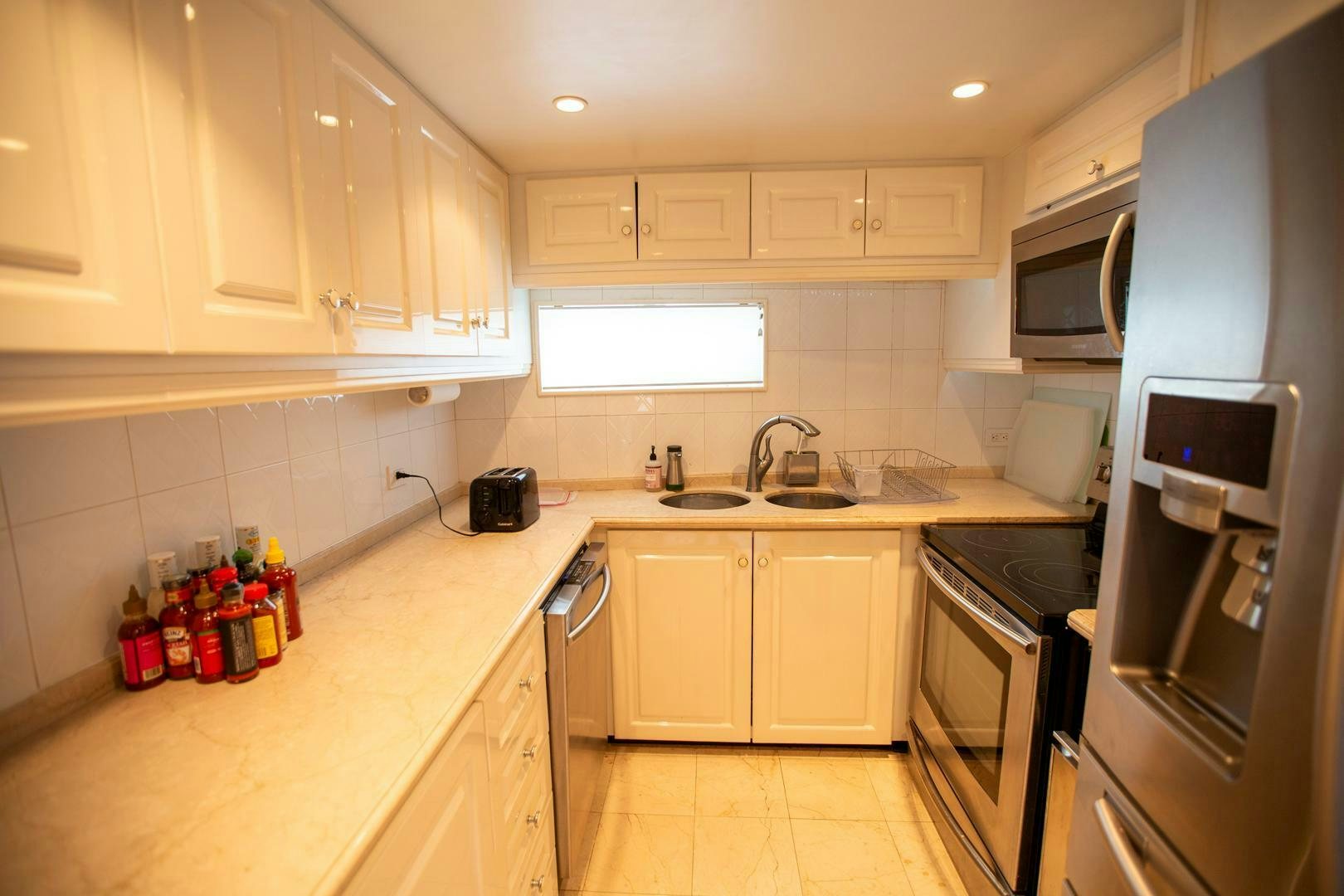 a kitchen with white cabinets aboard PAINKILLER Yacht for Sale