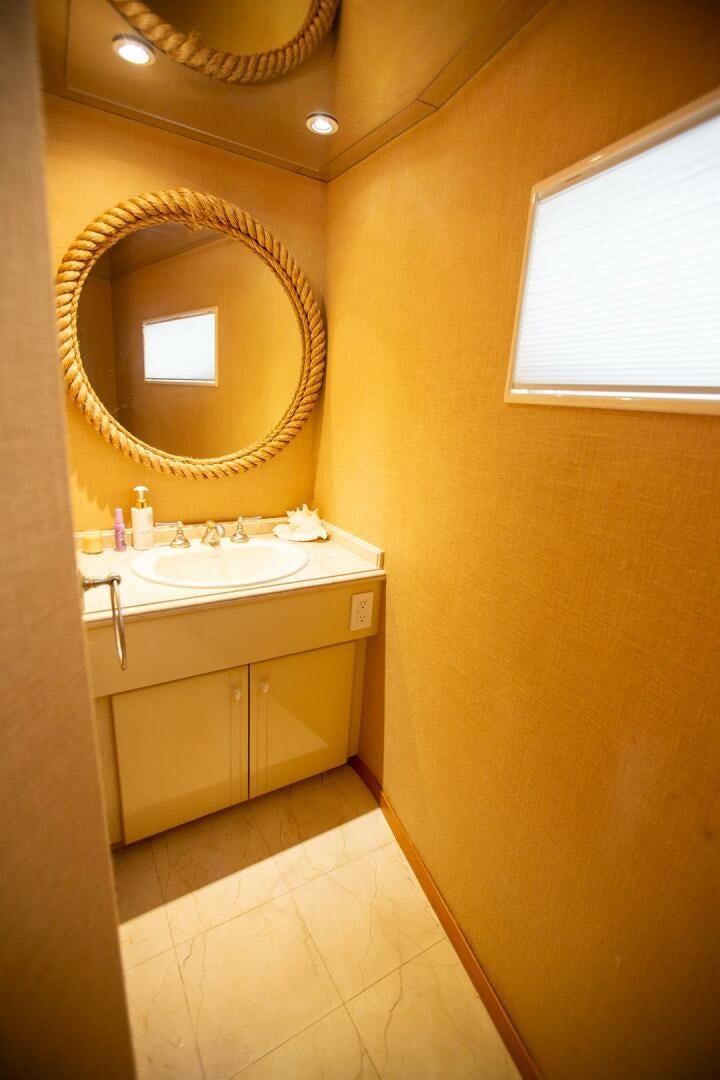 a bathroom with a mirror and a sink aboard PAINKILLER Yacht for Sale