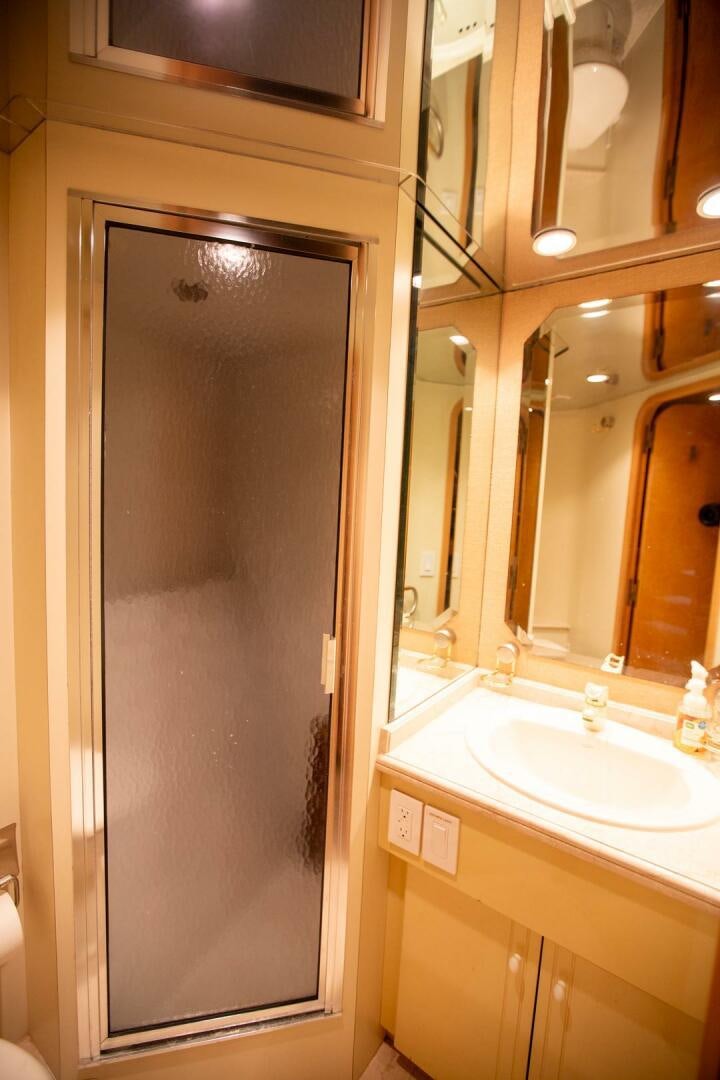 a bathroom with a shower and sink aboard PAINKILLER Yacht for Sale