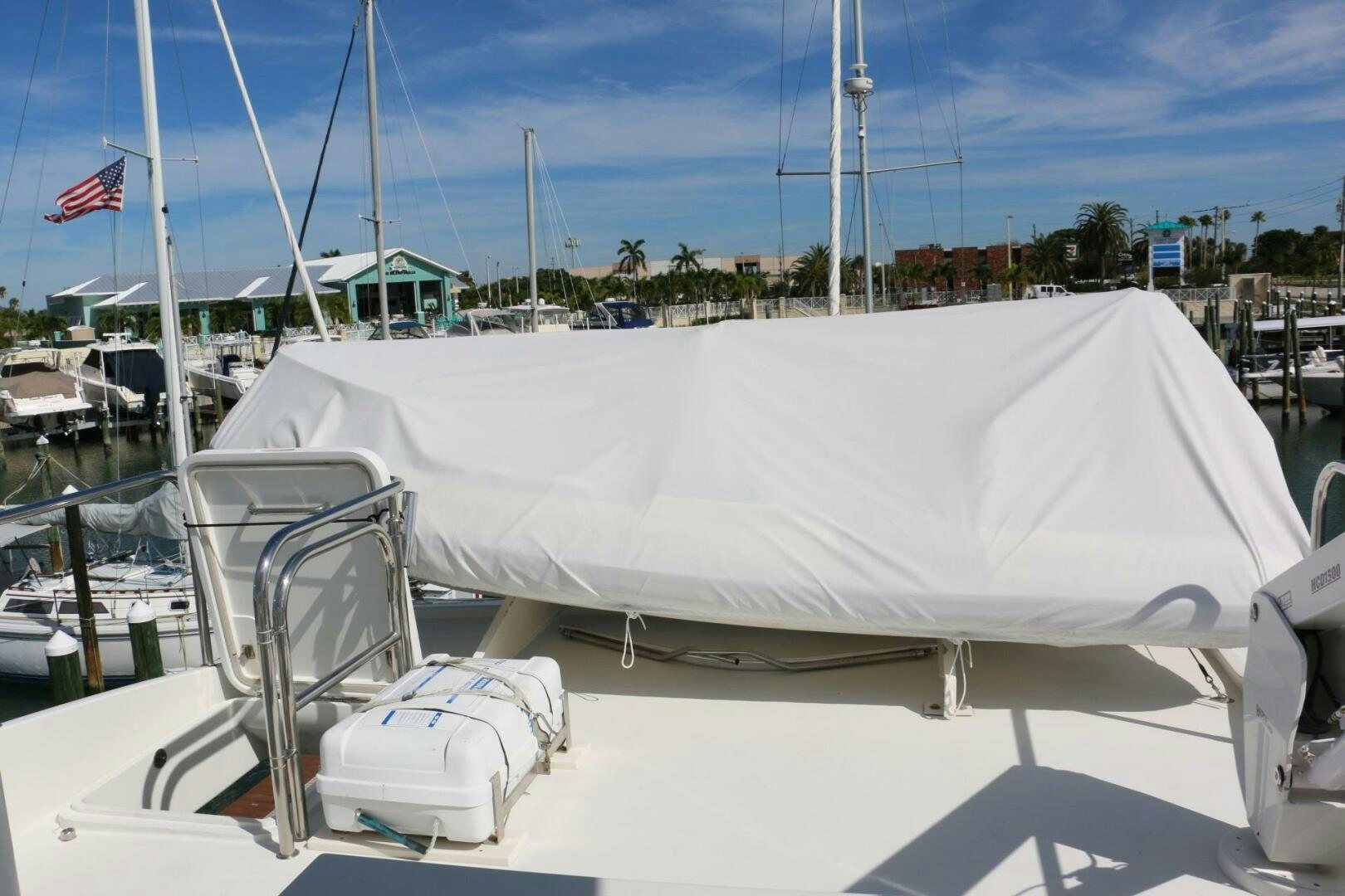 a white boat with a white canopy aboard RECYCLING MADE CENTS Yacht for Sale