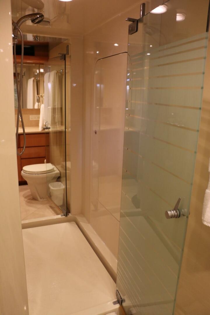 a bathroom with a glass shower door aboard RECYCLING MADE CENTS Yacht for Sale