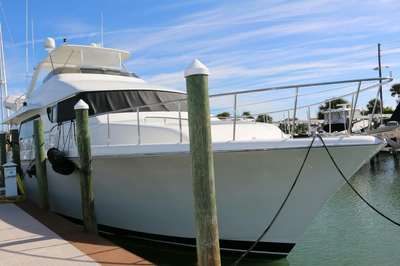 a white boat on a dock aboard RECYCLING MADE CENTS Yacht for Sale