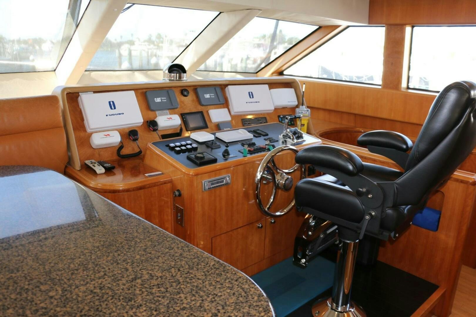 a leather chair in a room with a table with electronic devices on it aboard RECYCLING MADE CENTS Yacht for Sale