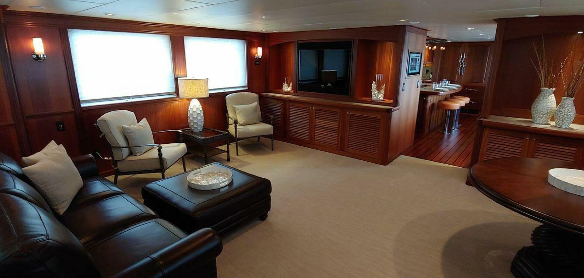 a living room with a leather couch and a television aboard ALLSEAS Yacht for Sale