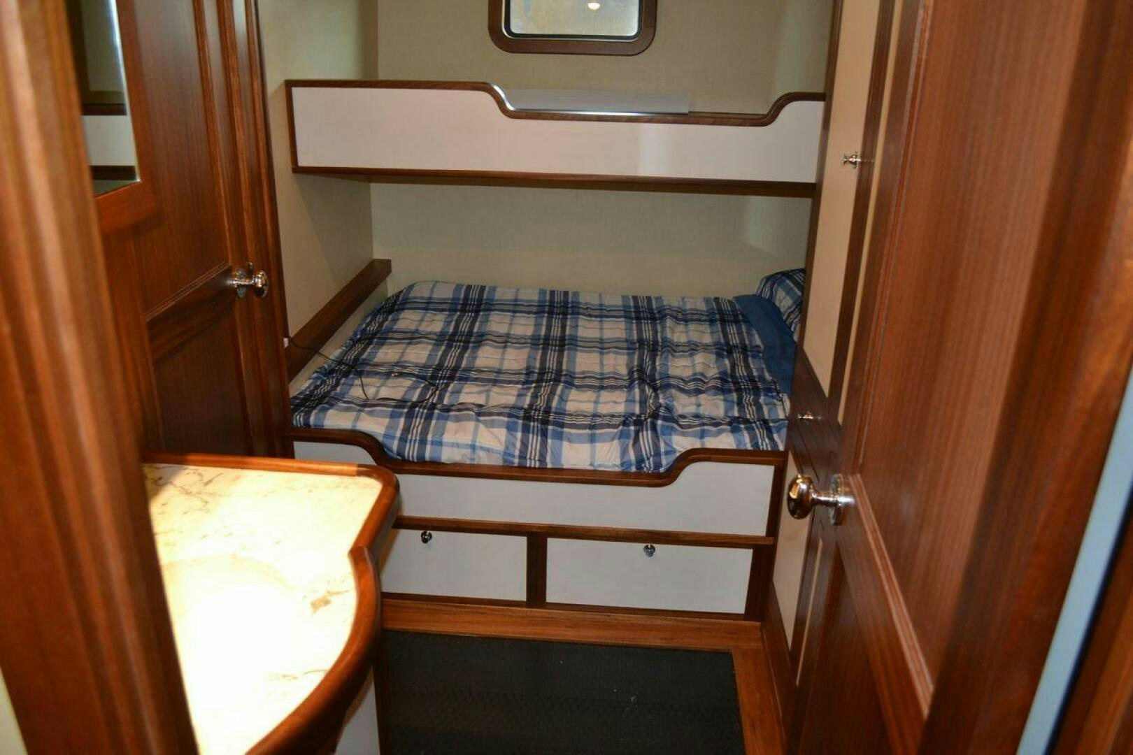 a bed with a blue comforter aboard ALLSEAS Yacht for Sale