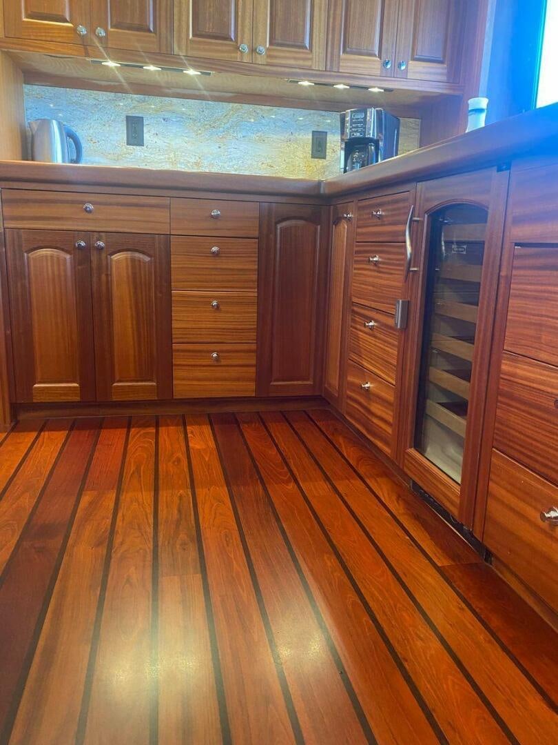 a kitchen with wooden cabinets aboard ALLSEAS Yacht for Sale