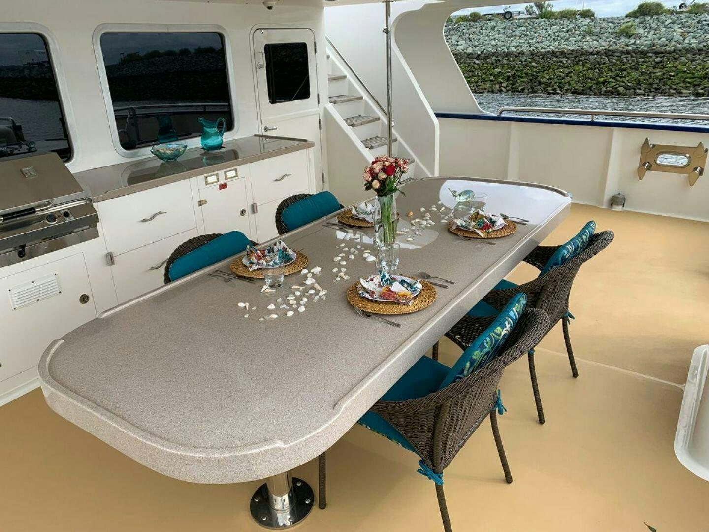 a kitchen with a table and chairs aboard ALLSEAS Yacht for Sale