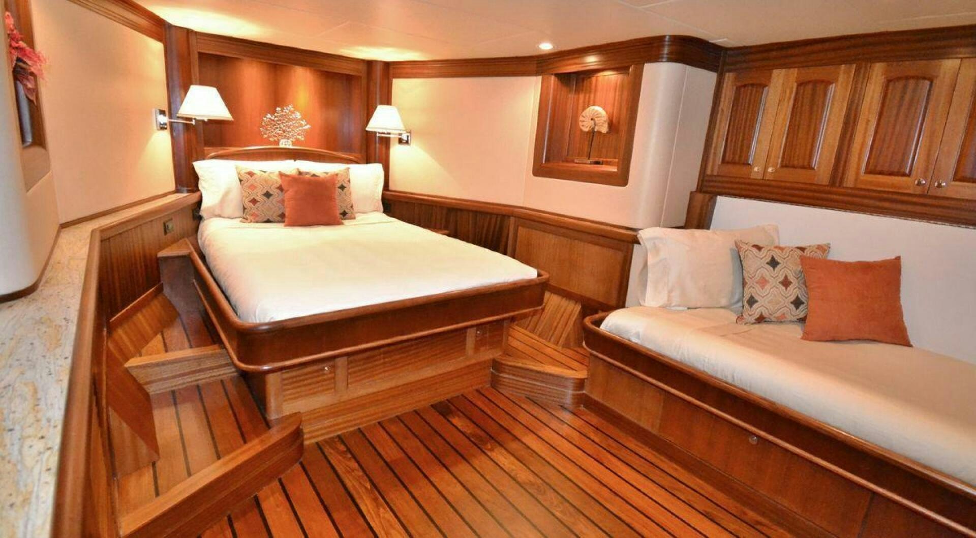 a room with a bed and a couch aboard ALLSEAS Yacht for Sale